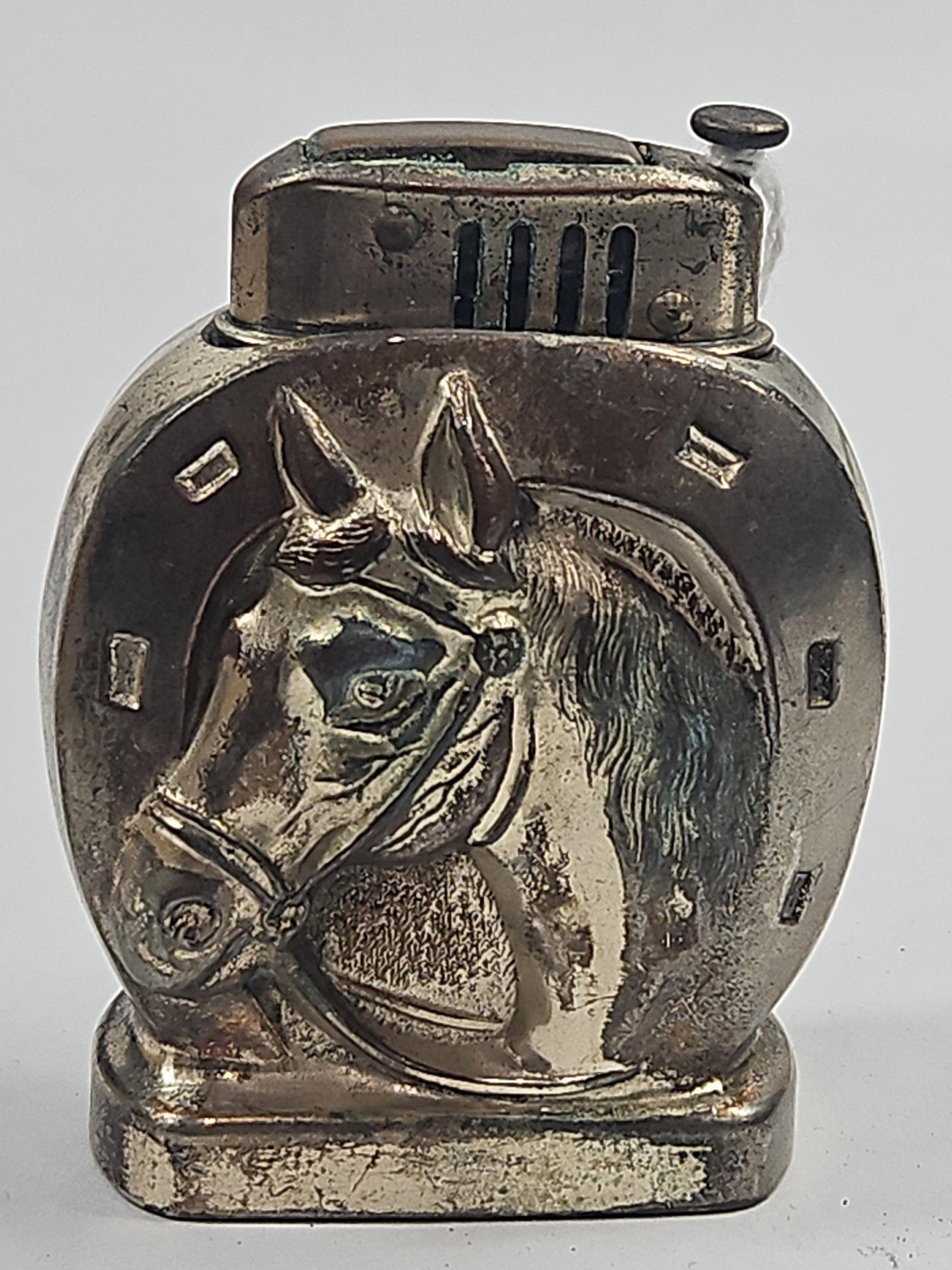 Vtg Occupied Japan Horse Relief Lighter: An equestrian-themed pocket lighter featuring a relief design of a bridled horse head within a horseshoe on both faces. The silver-toned metal body is fitted with a vertical thumb-plunge ignition