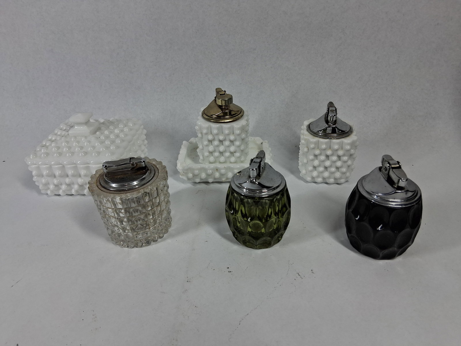 Vtg Glass Table Lighters & Trinket Box: An assortment of mid-20th-century glassware consisting of several table lighters and a coordinating lidded trinket box. The group features multiple pieces of opaque white glass in a hobnail pattern,
