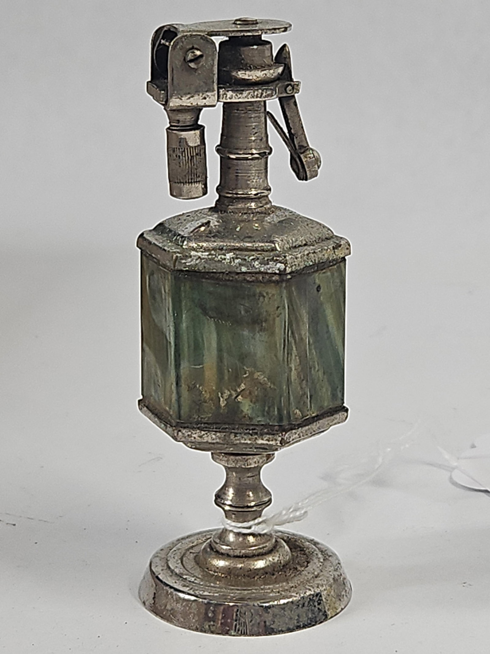 Japanese Octagonal Slag Glass Lighter: A Japanese vintage table lighter featuring an octagonal central body mounted on a tiered circular pedestal base. The body is composed of panels of marbled green and brown slag glass set within a