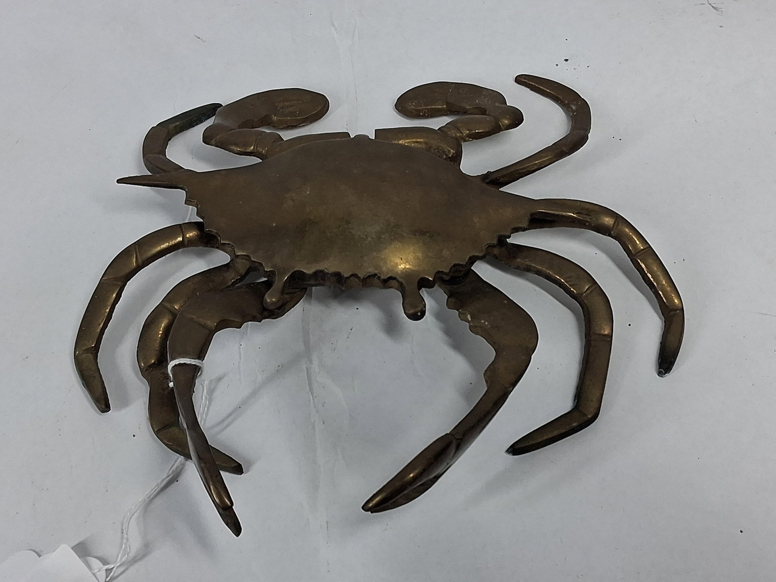 Brass Articulated Crab Ashtray & Box: A vintage cast brass decorative vessel modeled in the form of a crab with a dark golden-brown patina. The piece features a hinged carapace that opens to reveal a shallow, circular interior