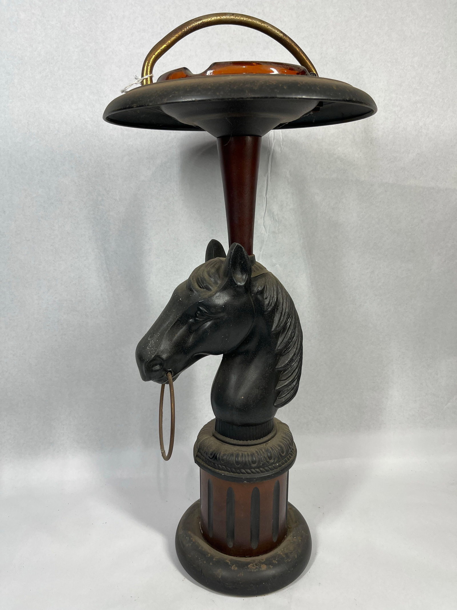 Horse Head Smoking Stand w/ Amber Glass: A mid-century floor-standing smoking stand featuring an equestrian theme. The central functional element is a cast metal horse head bust finished in a matte black tone. A movable metal hitching ring