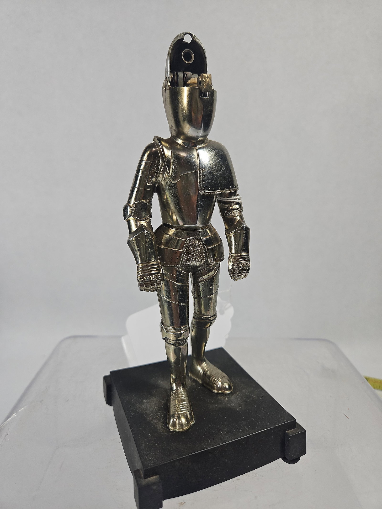 Hamilton Wedemeyer Knight Table Lighter: An American chrome-plated metal figural table lighter modeled as a standing knight in full armor. The figure is mounted on a rectangular black base with a textured finish. The knight is depicted in a 