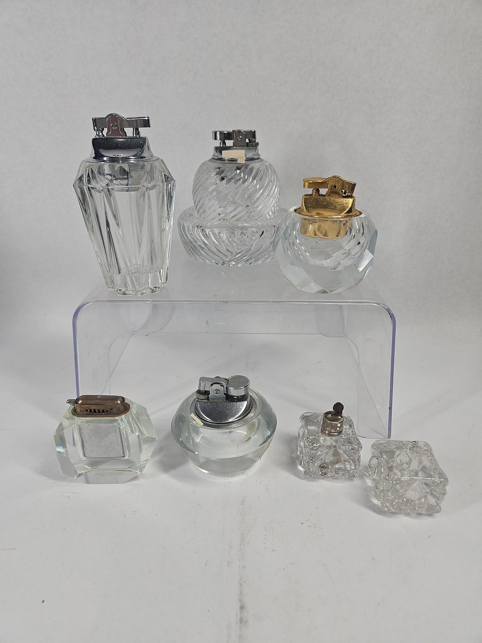 Viking & Prince Glass Lighters & Acc: An assortment of vintage clear glass table lighters and coordinating accessories. The collection includes a bulbous clear glass lighter featuring a gold foil adhesive label with a stylized ship logo