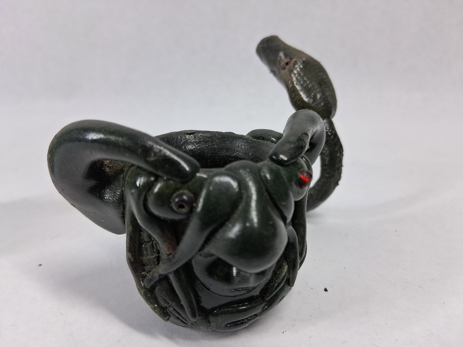 Pair Grotesque Figural Snake Stem Pipes: A pair of handcrafted figural smoking pipes, each featuring a bowl sculpted in the form of a horned, grotesque creature's head. The stems are modeled into long, sinuous snake bodies, terminating in