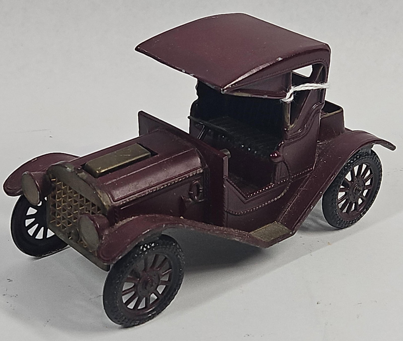 Japanese Royal London 1910 Hudson Car: This heavy Japanese cast metal model of a 1910 Hudson was produced for Royal London Ltd. The vehicle is finished in a burgundy color with a black chassis and spoked wheels. The model depicts a