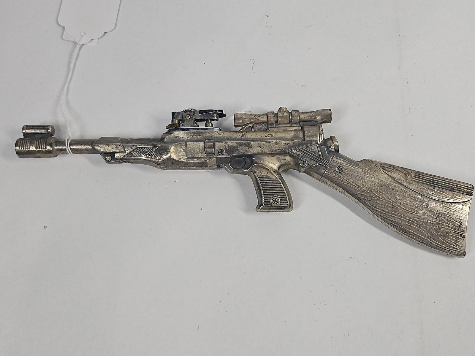 Japanese Sci-Fi Rifle Table Lighter: A Japanese novelty table lighter cast in the form of a futuristic or science-fiction-inspired rifle. The body is constructed from two cast metal halves joined by Phillips head screws, featuring an
