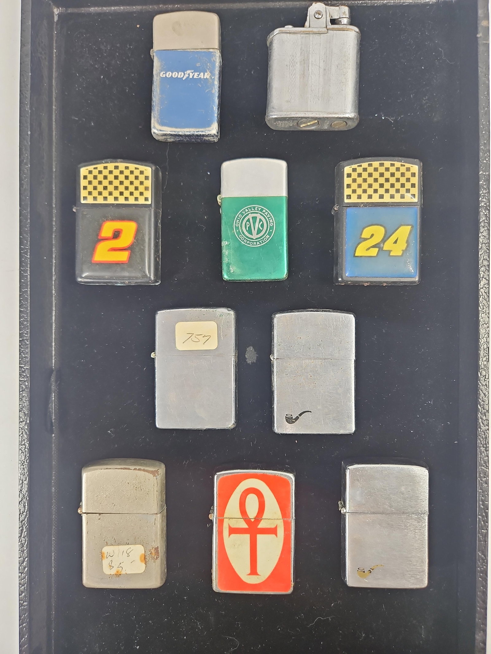 10 Zippo, Imperial & Specialty Lighters: A collection of ten pocket lighters featuring various advertising, racing, and specialty themes. The assortment includes several genuine Zippo brand items and one Imperial brand lighter. The