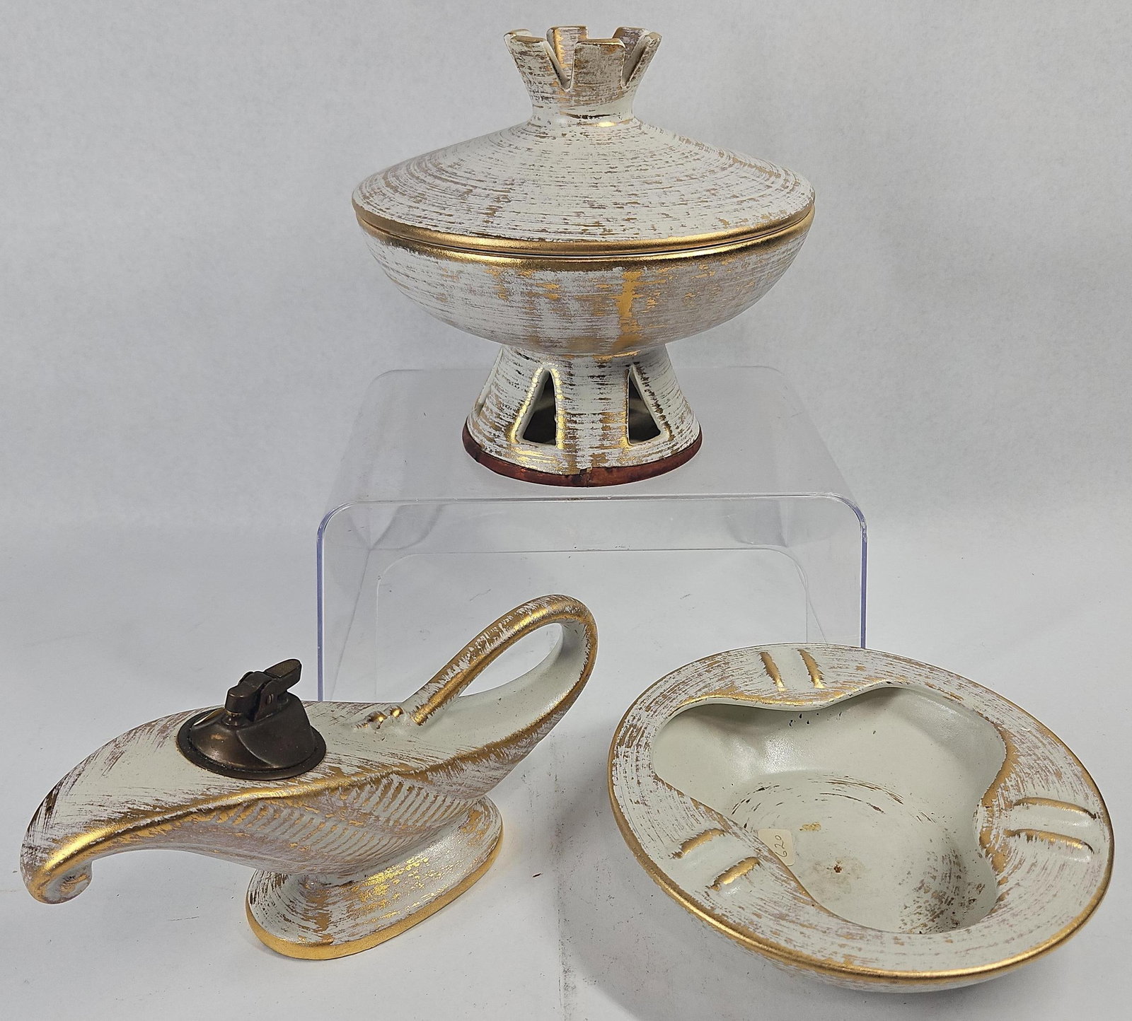 Royal Haeger Gold Tweed Smoking Set: An American-made glazed earthenware smoking set comprising a table lighter, an ashtray, and a lidded pedestal bowl. The set features a textured gold overglaze decoration, often referred to as a gold t