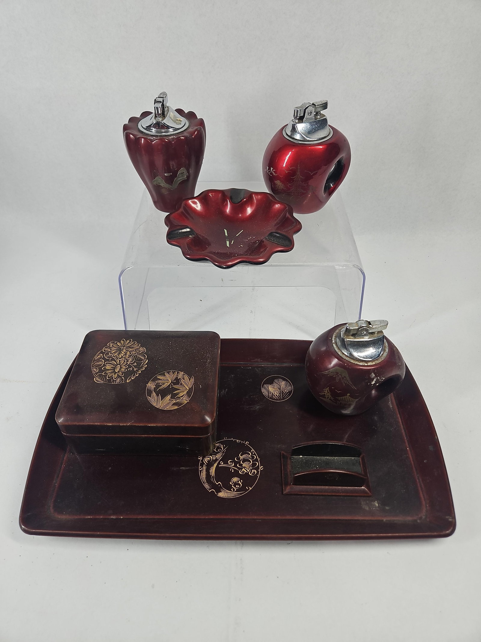 7pc Japanese Export Smoking Set: A seven-piece Japanese export smoking accessory set featuring two distinct decorative finishes. The collection is constructed from molded synthetic resin finished with lacquer-style treatments and