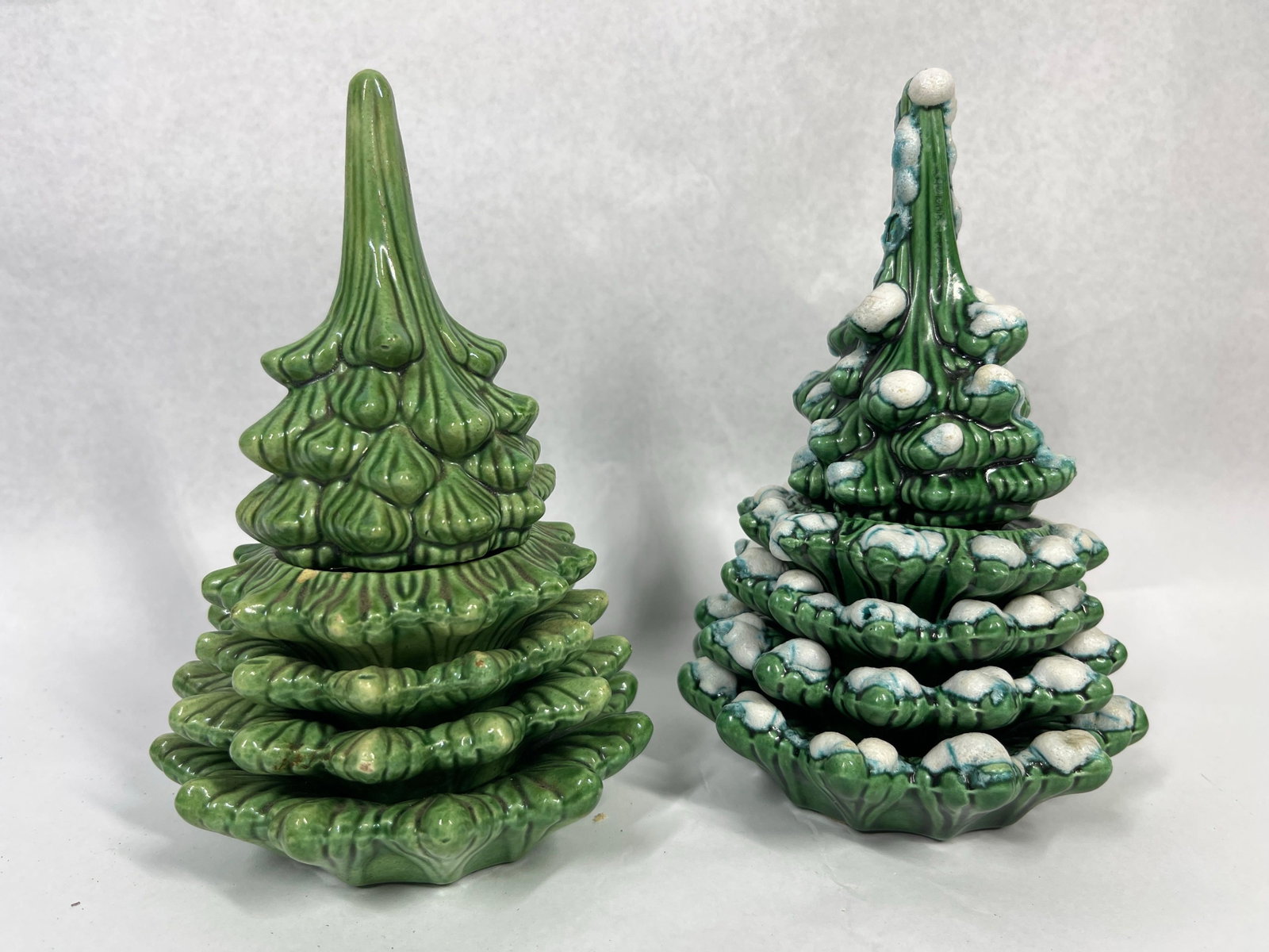 Pair Vtg Ceramic Christmas Tree Sets: A pair of glazed earthenware Christmas tree-themed table lighter and ashtray sets. Each assembly is composed of five separate pieces: a conical topper housing a removable metal lighter mechanism and f