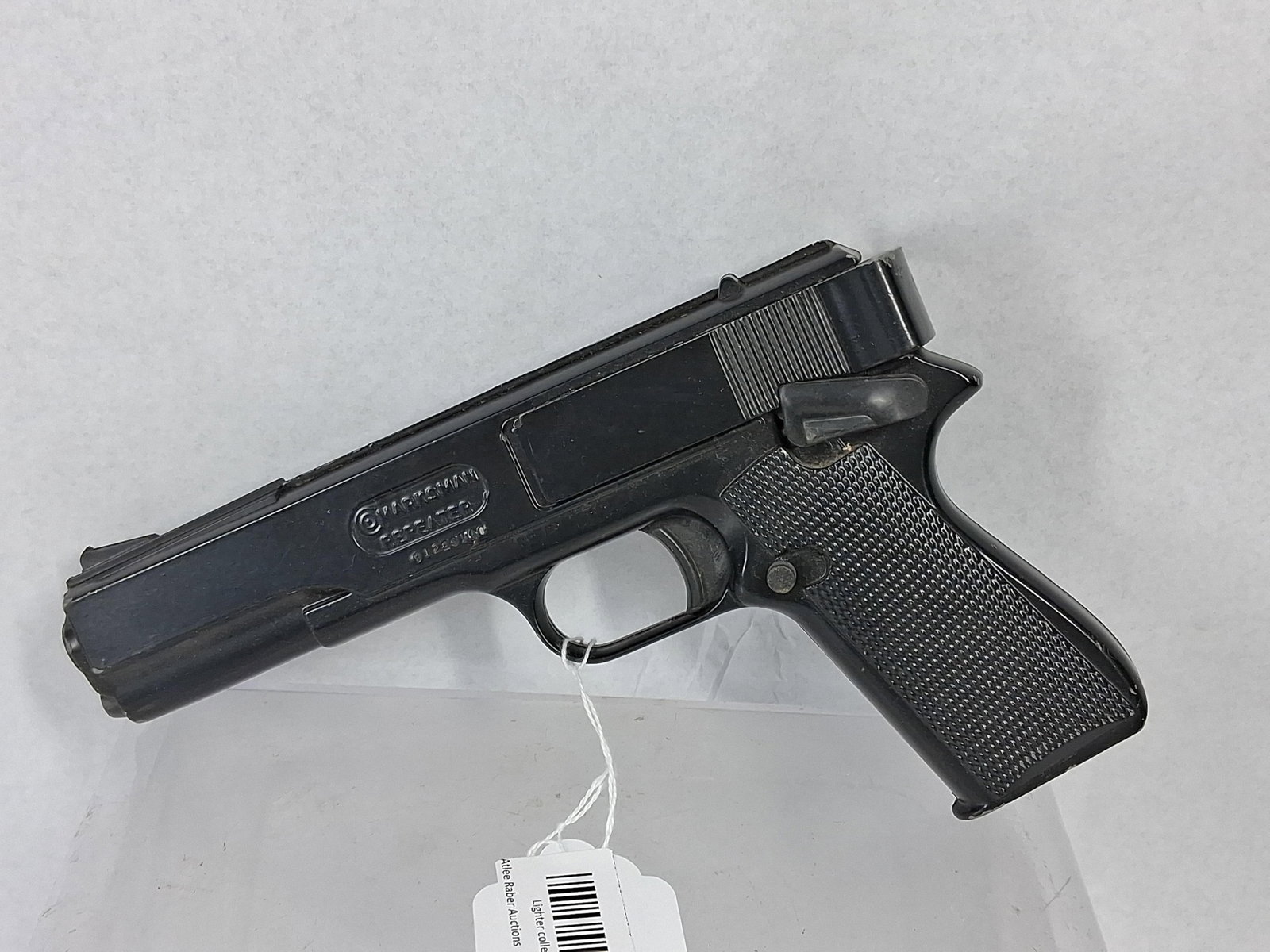 Marksman Repeater Air Pistol: A Huntington Beach, California, manufactured spring-powered air pistol constructed with a die-cast metal frame and slide featuring a black finish and checkered plastic grips. The pistol is designed fo