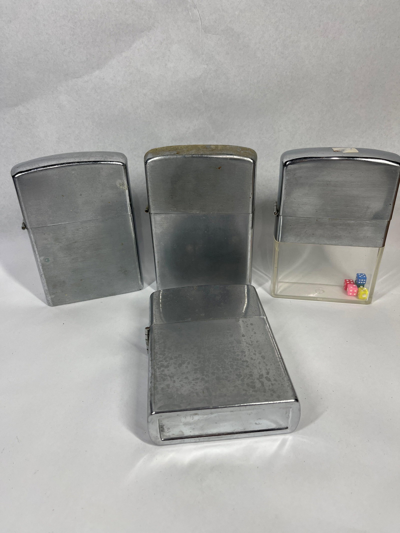 Set 4 Novelty Table Lighters: A group of four oversized novelty table lighters constructed with a flip-top mechanism. The assortment includes three units featuring all-metal cases in brushed and polished chrome-tone finishes,