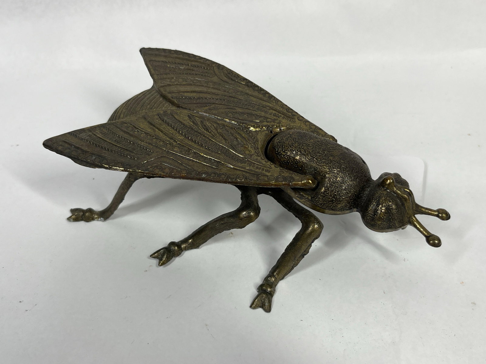 Vintage Cast Brass Fly Form Lidded Box: A cast brass decorative lidded box modeled in the form of a fly. The piece features two hinged wings that open upward to reveal a hollow central compartment. The wings are embellished with intricate