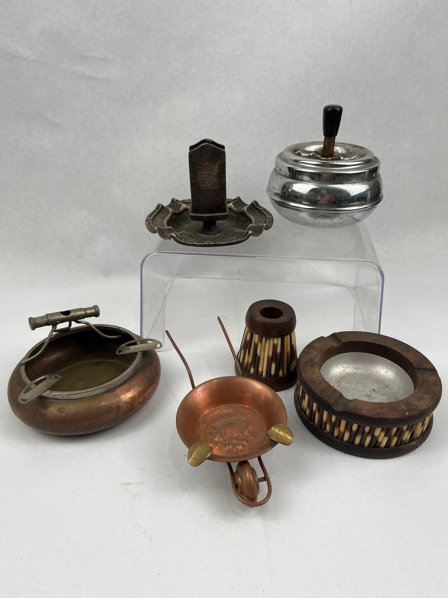 Reed & Barton Wood & Metal Smoking Set: This group of vintage smoking accessories includes items crafted from copper, silver-plate, chrome, and olive wood. A Reed & Barton silver-soldered ashtray with an integrated matchbox holder is impres