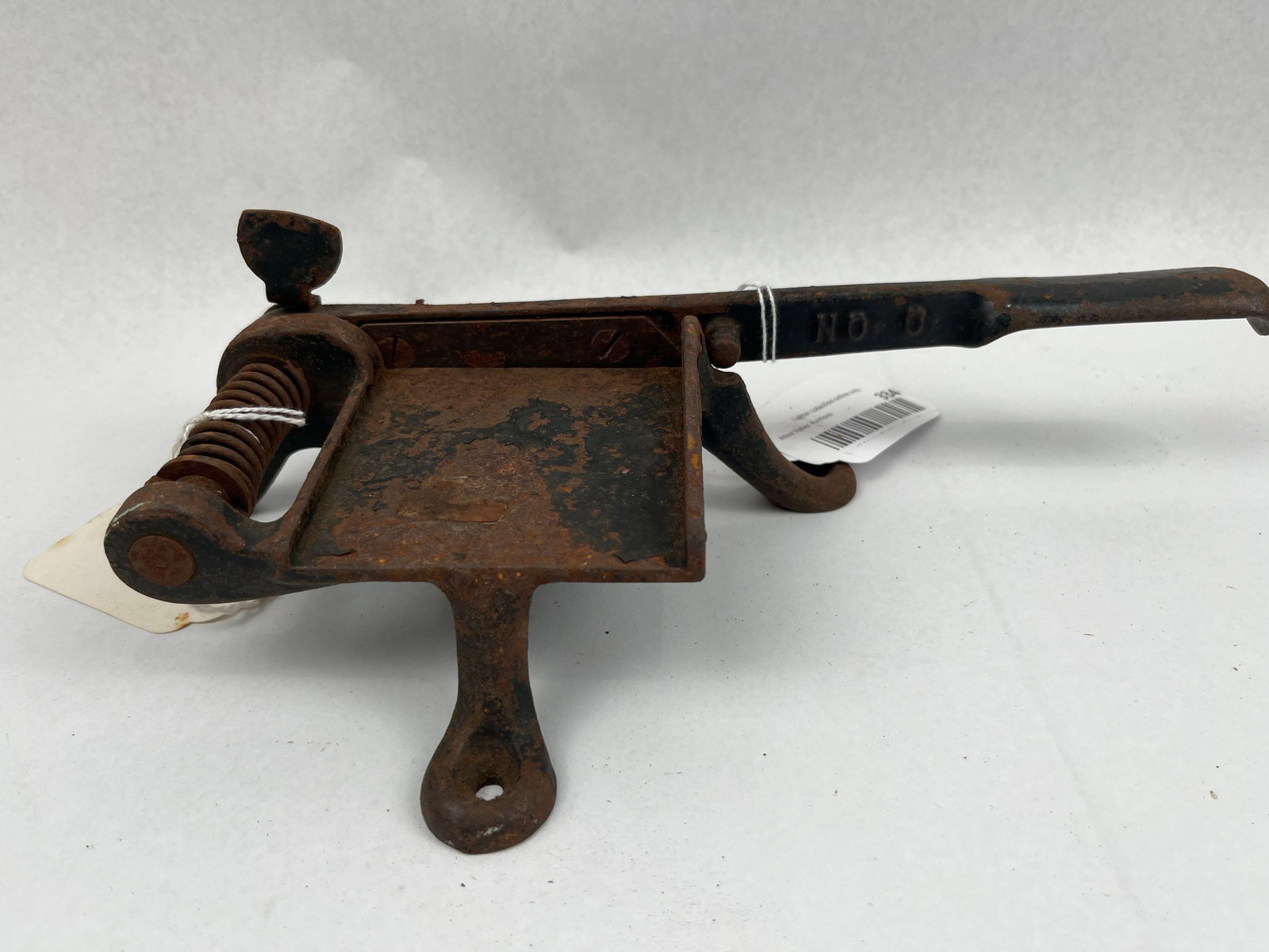 Yankee Slicer No. 0 Iron Tobacco Cutter: This is a cast iron tabletop tool designed for slicing plug tobacco or utility materials. The device features a heavy rectangular bed with raised side walls to guide the material being sliced. It is