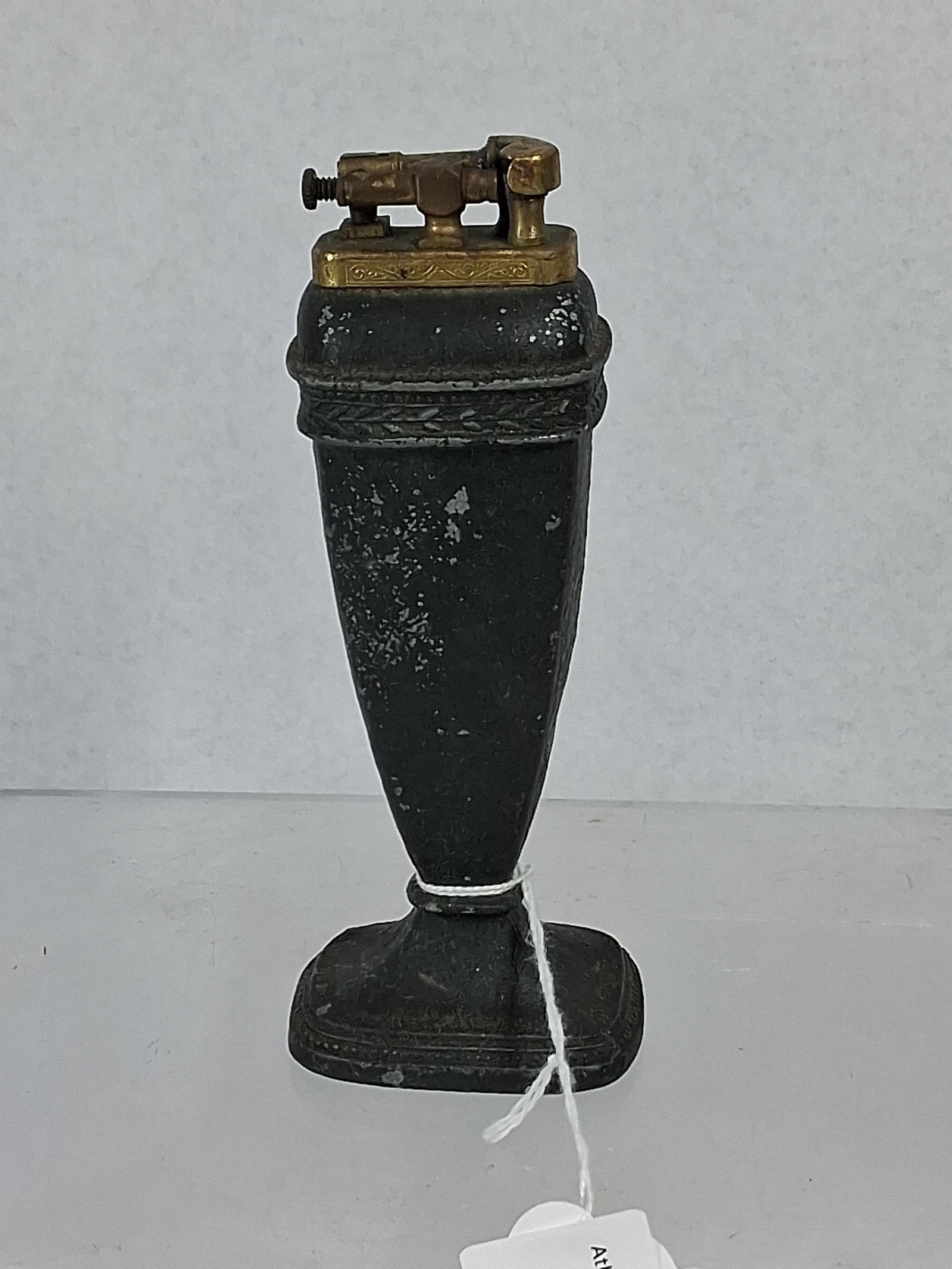 Cast Metal Urn Lift-Arm Table Lighter: A manual lift-arm table lighter designed in the form of a classical urn mounted on a pedestal with a rectangular base. The body is constructed of cast metal and finished with a dark, crackle-textured