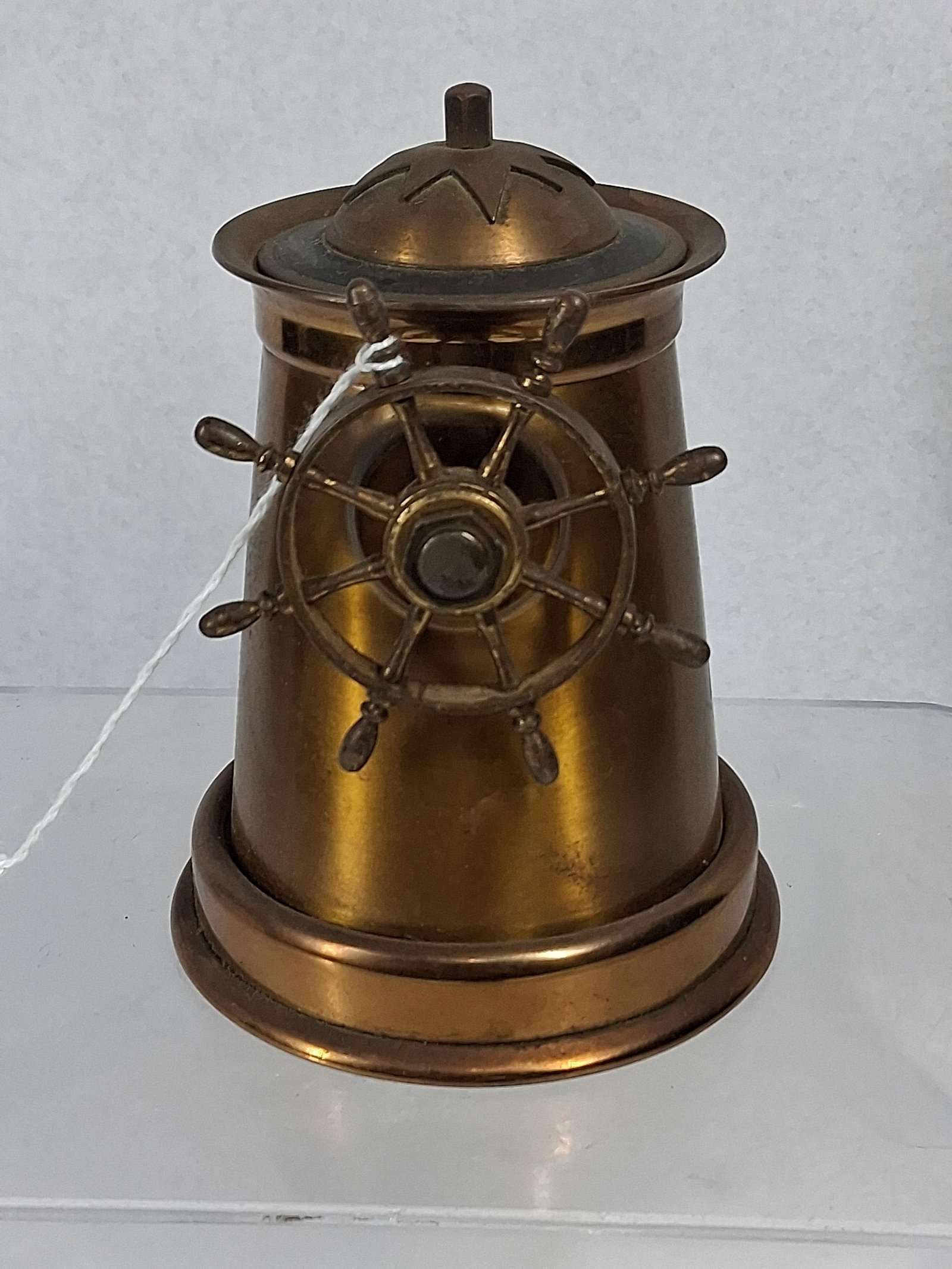 Brass Binnacle Form Cigarette Dispenser: A vintage mechanical cigarette or match dispenser constructed of brass, designed in the form of a nautical binnacle or ship capstan. The item features a tapering cylindrical body formed from sheet bra