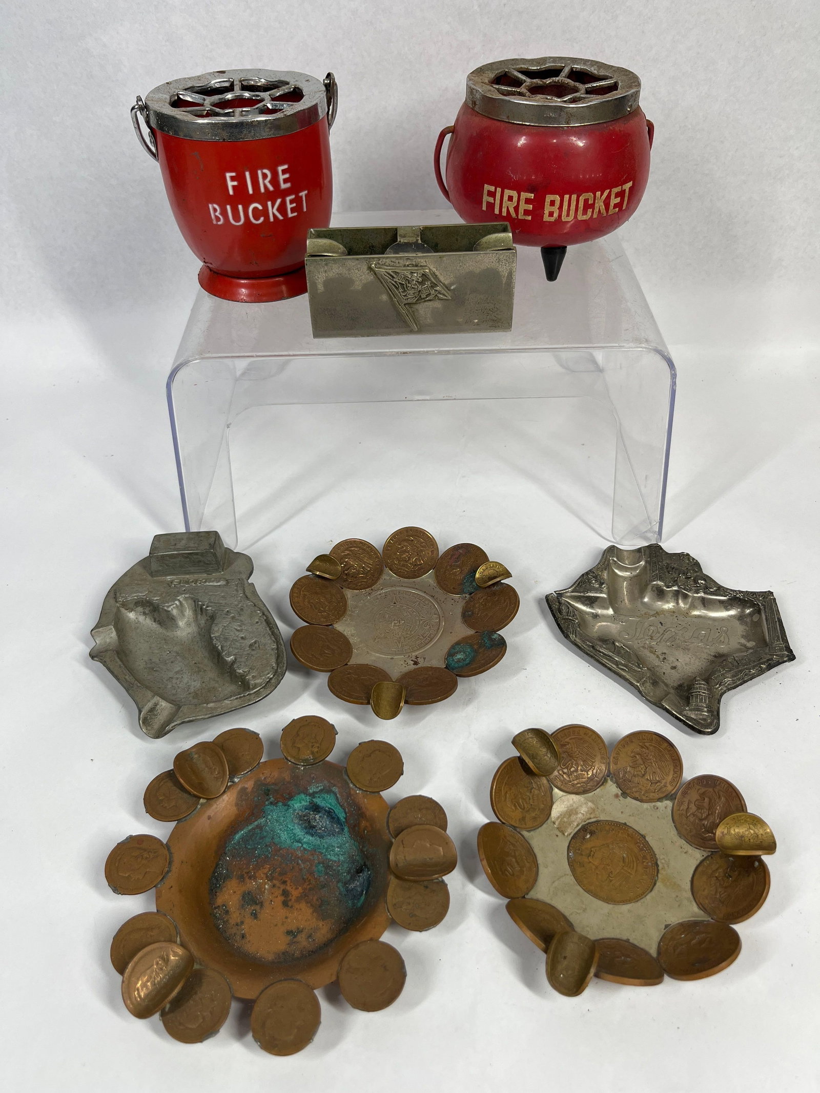 Vtg Novelty, Souvenir & Coin Ashtrays: A collection of vintage metal ashtrays featuring novelty, souvenir, and numismatic themes. The group includes two red-painted metal novelty fire bucket ashtrays with removable chrome-plated grate