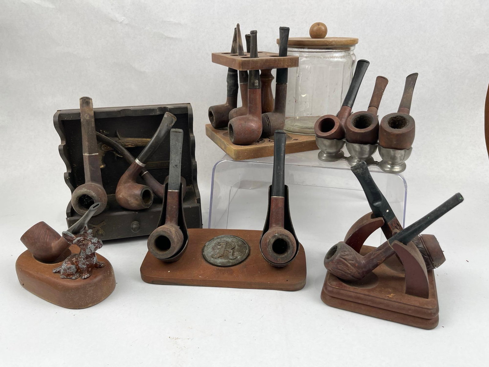 Vtg Briar Pipes & Tobacco Accessories: An assortment of vintage smoking pipes and related accessories featuring various briar wood pipes and specialized stands. The collection includes pipes with legible markings such as a straight grain
