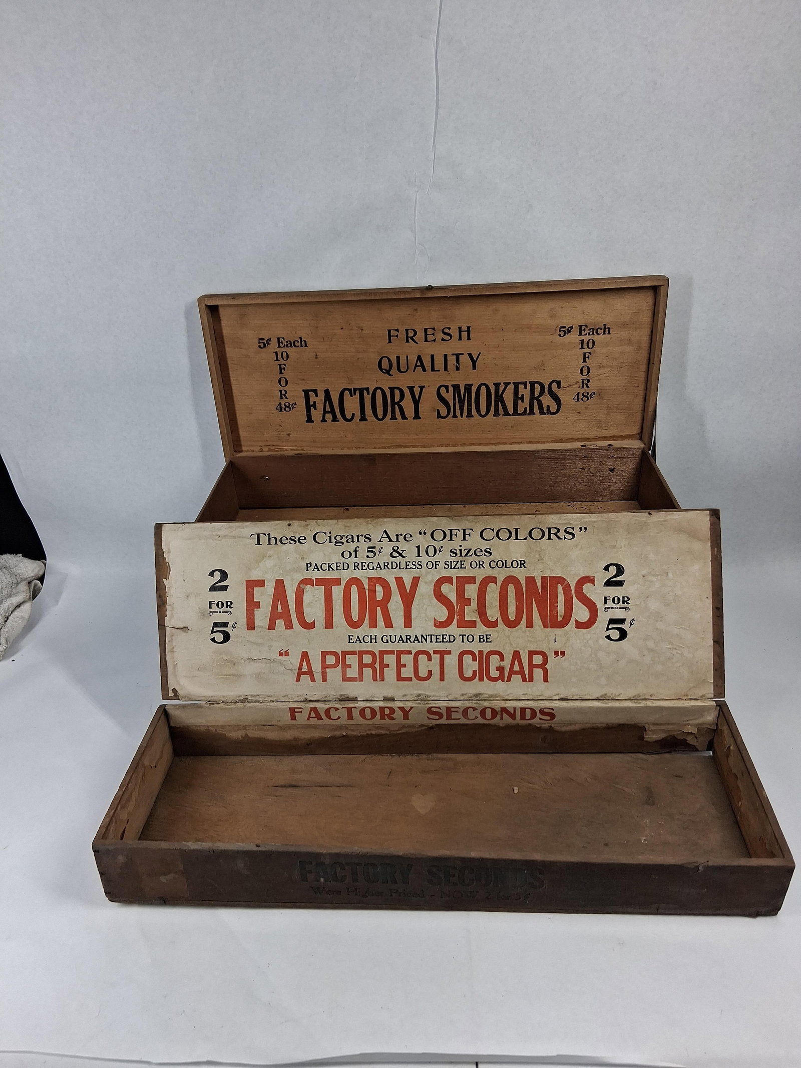 Two Vtg Wooden Advertising Cigar Boxes: A pair of vintage wooden cigar boxes designed for retail display, featuring advertising for budget tobacco products from the early to mid-20th century. The first box is constructed from wood with