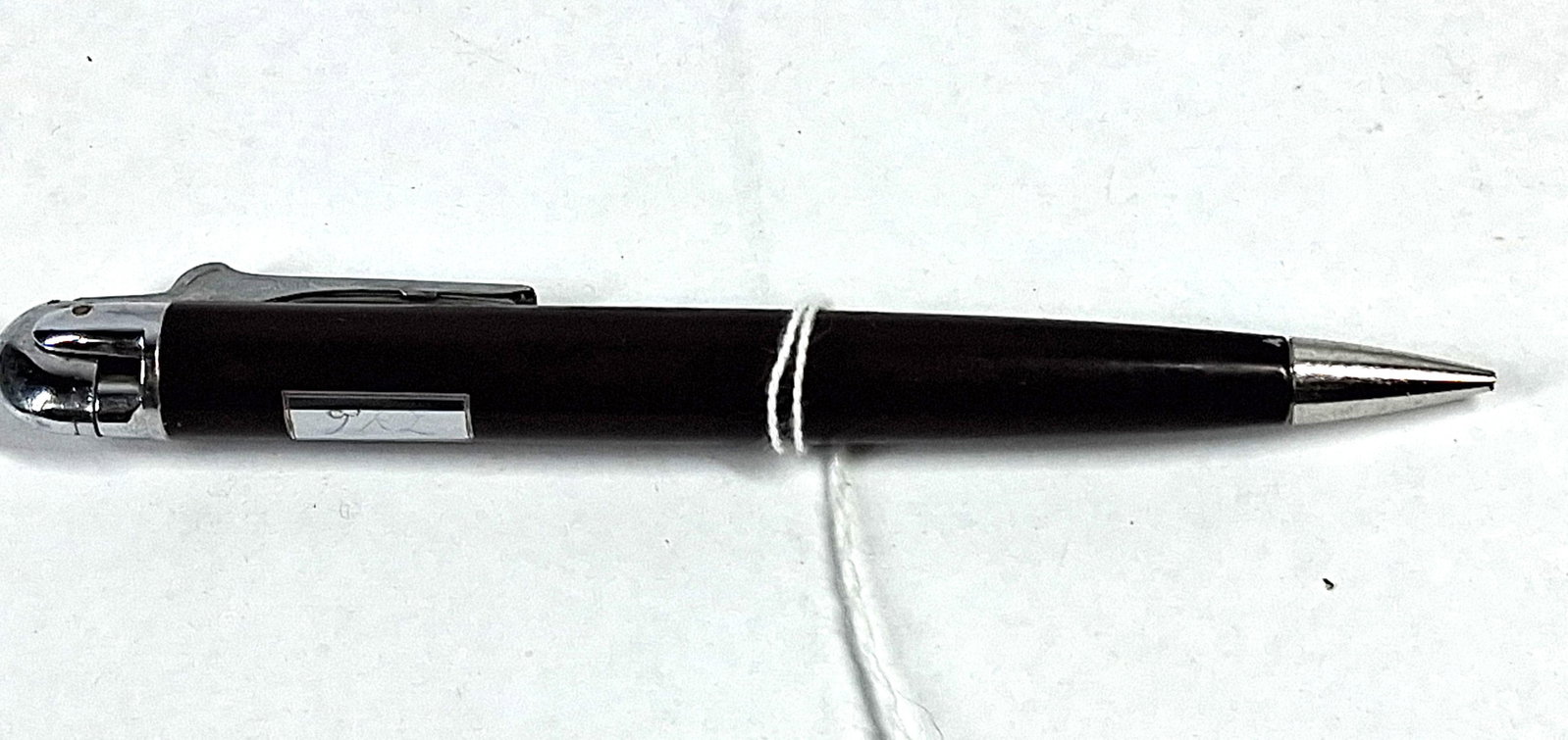 Ronson Brown Enamel Pencil & Lighter: This mid-century combination writing instrument and cigarette lighter features a tapered barrel with a dark brown lacquer or enamel finish over a metal body. The functional components, including the