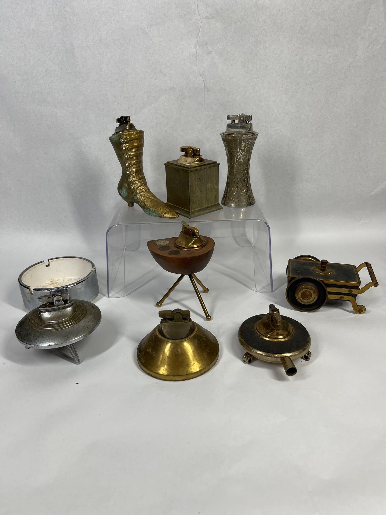 Vtg Novelty & Mid-C. Smoking Collection: An assortment of table lighters featuring various figural and geometric forms. A Victorian-style boot lighter in brass-toned metal is decorated with clear rhinestone buttons along the front; the heel