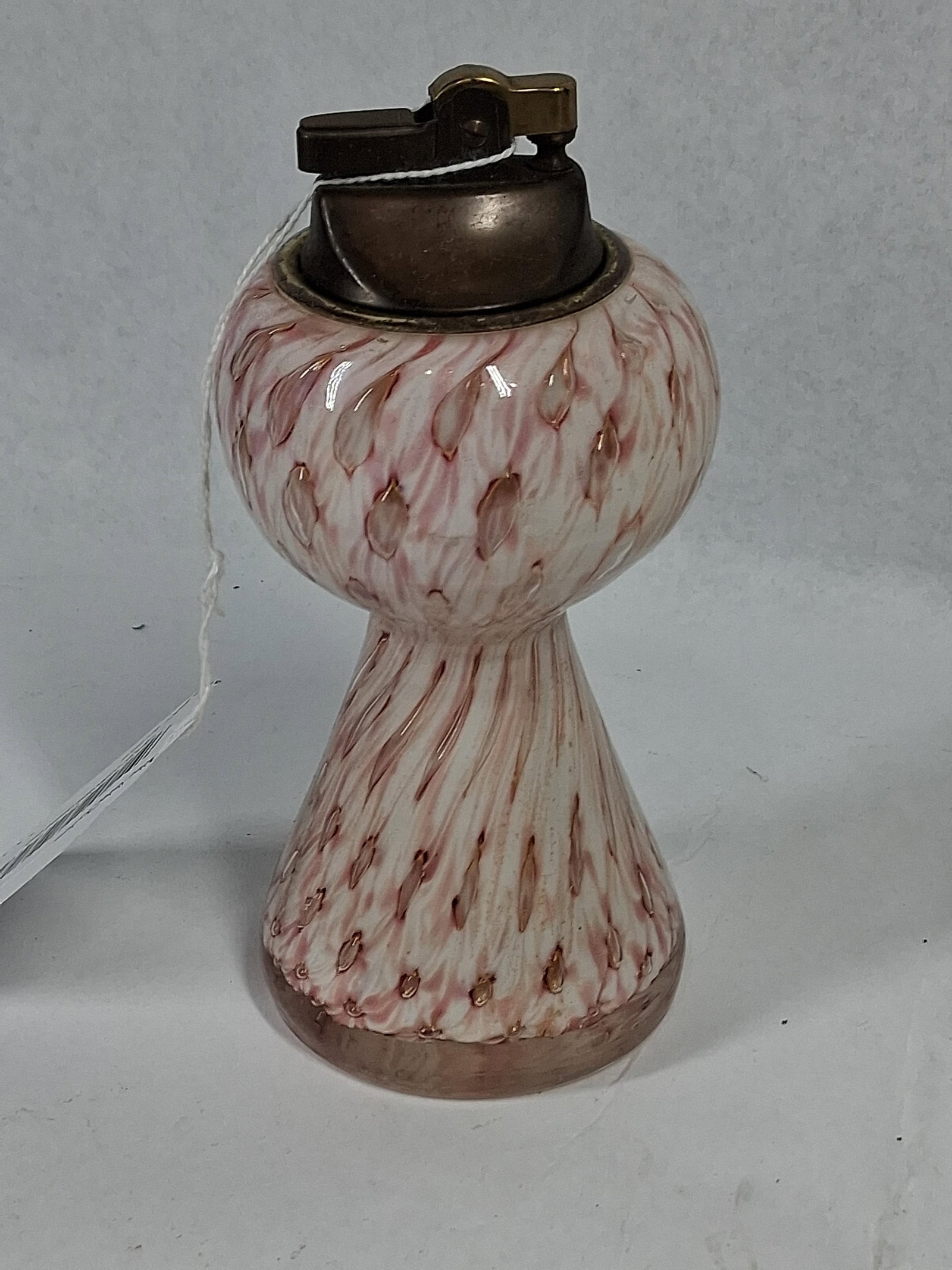 Bullicante Table Lighter w/ Gold Foil: This vintage table lighter is constructed from a hand-blown art glass body featuring an hourglass or flared pedestal form. The glass incorporates opaque white and cranberry pink swirls in a spiral