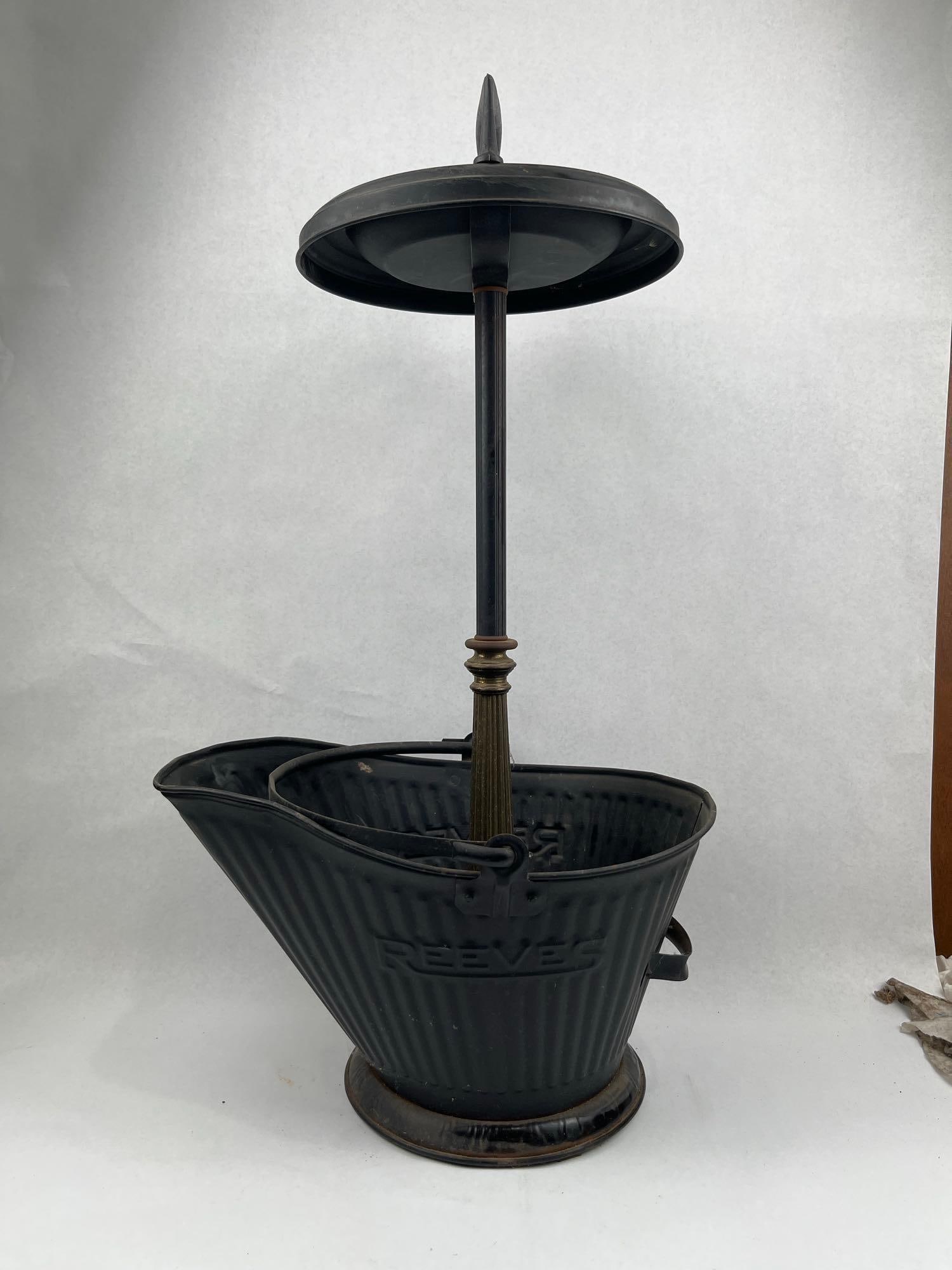 Reeves Smoking Stand & Coal Scuttle: This industrial floor-standing smoking companion features an integrated coal scuttle base. The assembly is constructed from black-painted metal, likely galvanized steel or iron, with a decorative
