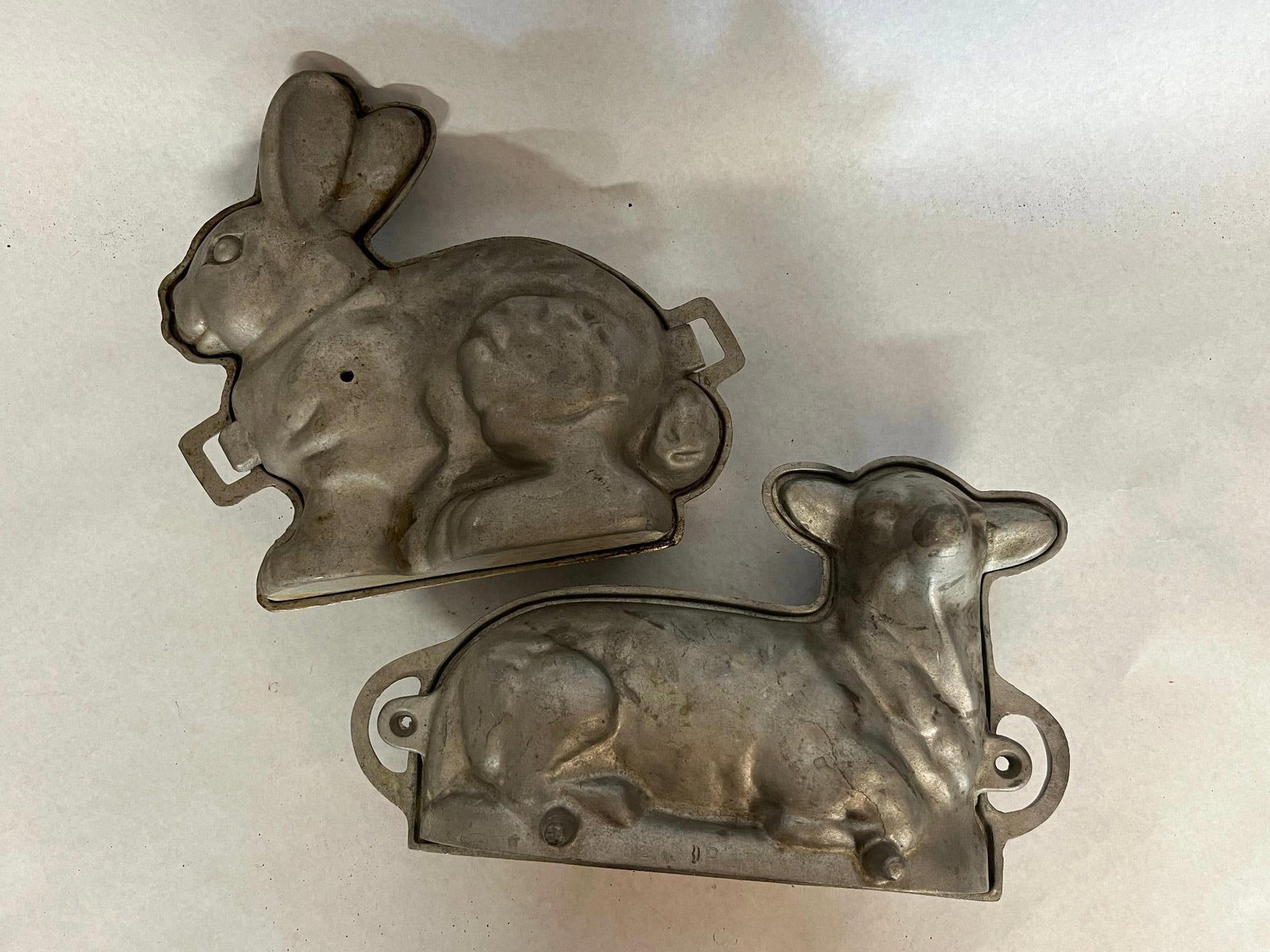 Pair Cast Aluminum Lamb & Rabbit Molds: A pair of two-piece figural baking molds constructed from heavy cast aluminum. The collection includes one mold in the form of a recumbent lamb and one in the form of a seated rabbit.