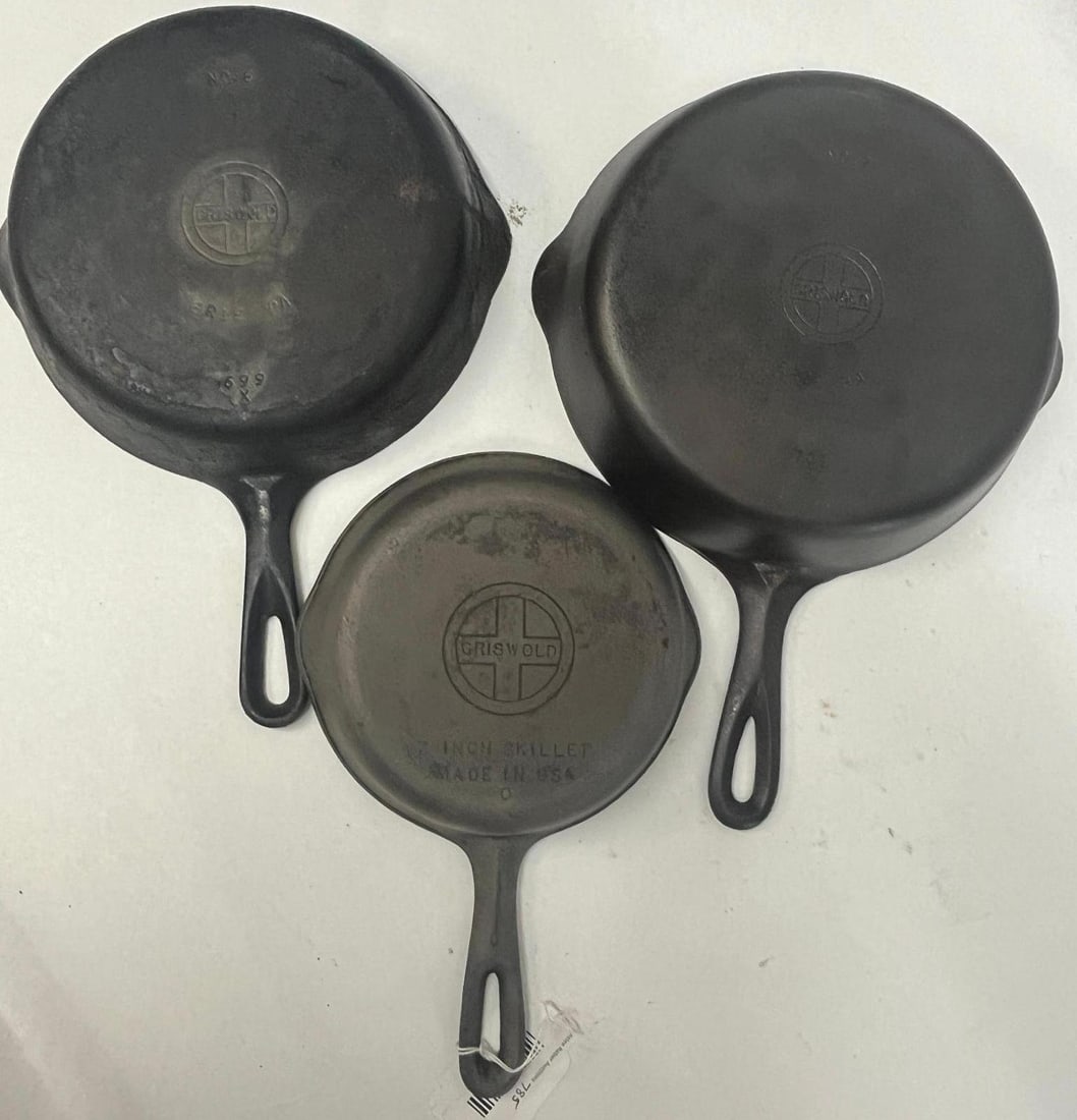 Griswold Small Logo Cast Iron Skillets: This lot comprises three American-made cast iron skillets produced by Griswold. The first skillet is an impressed number 8 size, featuring an impressed mark at the top of the base reading NO. The