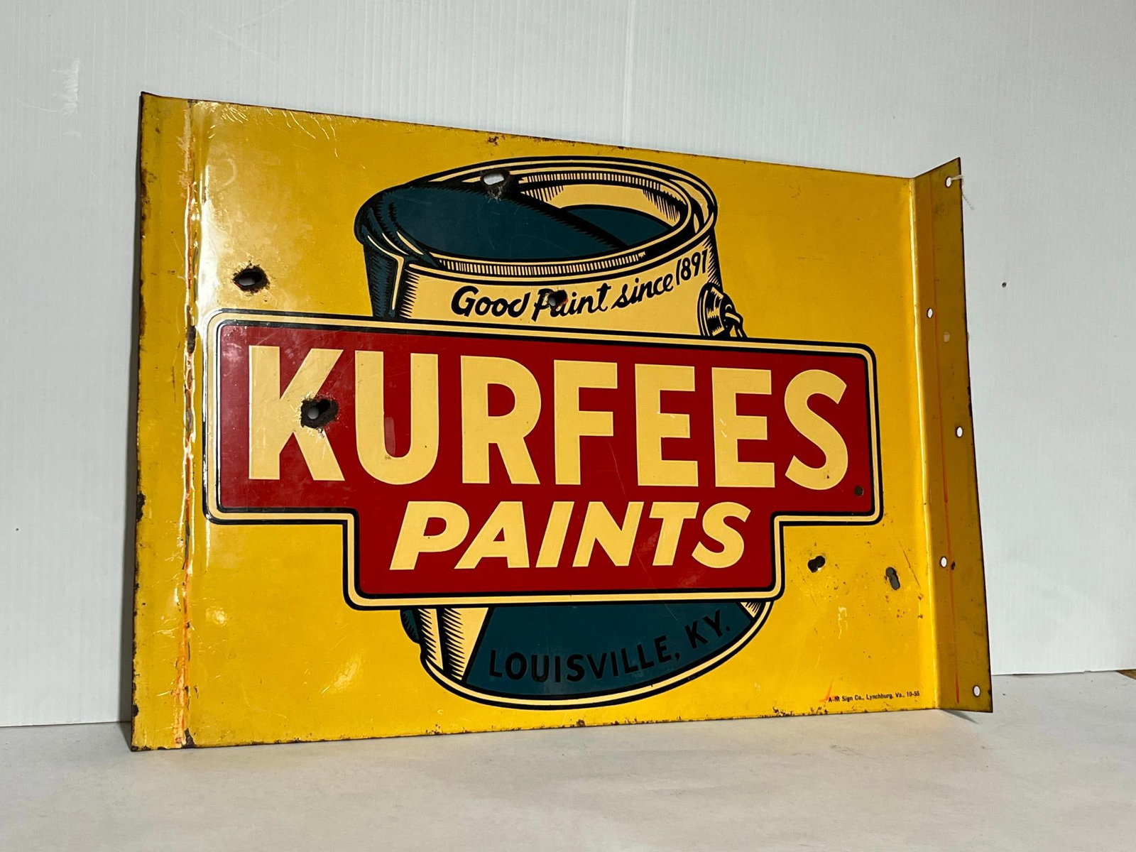 Kurfees Paints Metal Flange Sign: A double-sided metal flange advertising sign for Kurfees Paints of Louisville, Kentucky. The sign is constructed of enameled or painted metal and features a bright yellow field. The paint can graphic