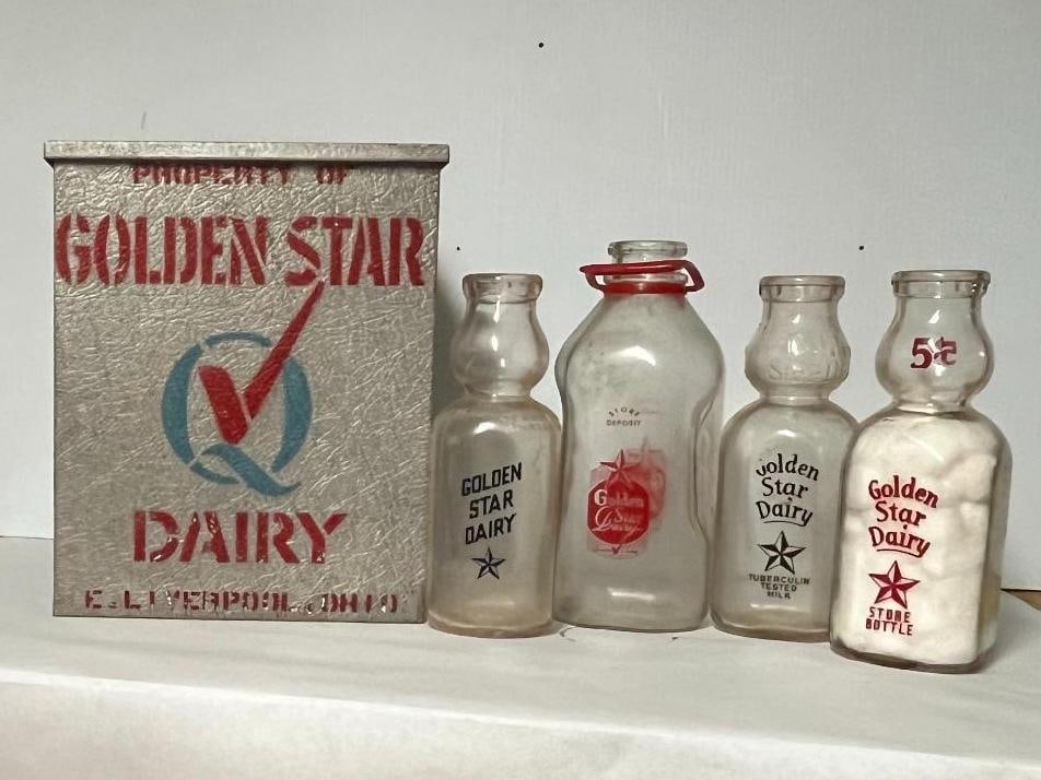 Golden Star Dairy Porch Box & Bottles: A collection of dairy advertising items from Golden Star Dairy in East Liverpool, Ohio, dating to the mid-20th century. The set includes a galvanized metal porch delivery box and several glass milk
