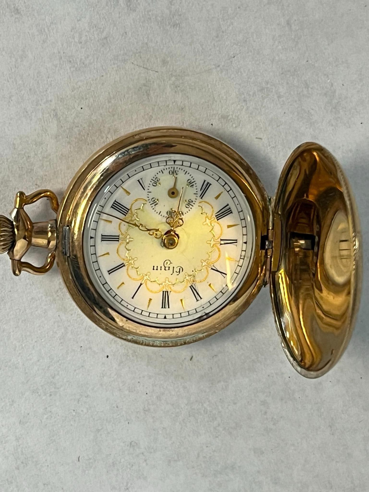 Elgin Gold Filled Hunting Pocket Watch: An Elgin National Watch Company ladies hunting case pocket watch featuring a manual wind mechanical movement. The movement plate is damaskeened in a nickel finish and is marked with the serial number