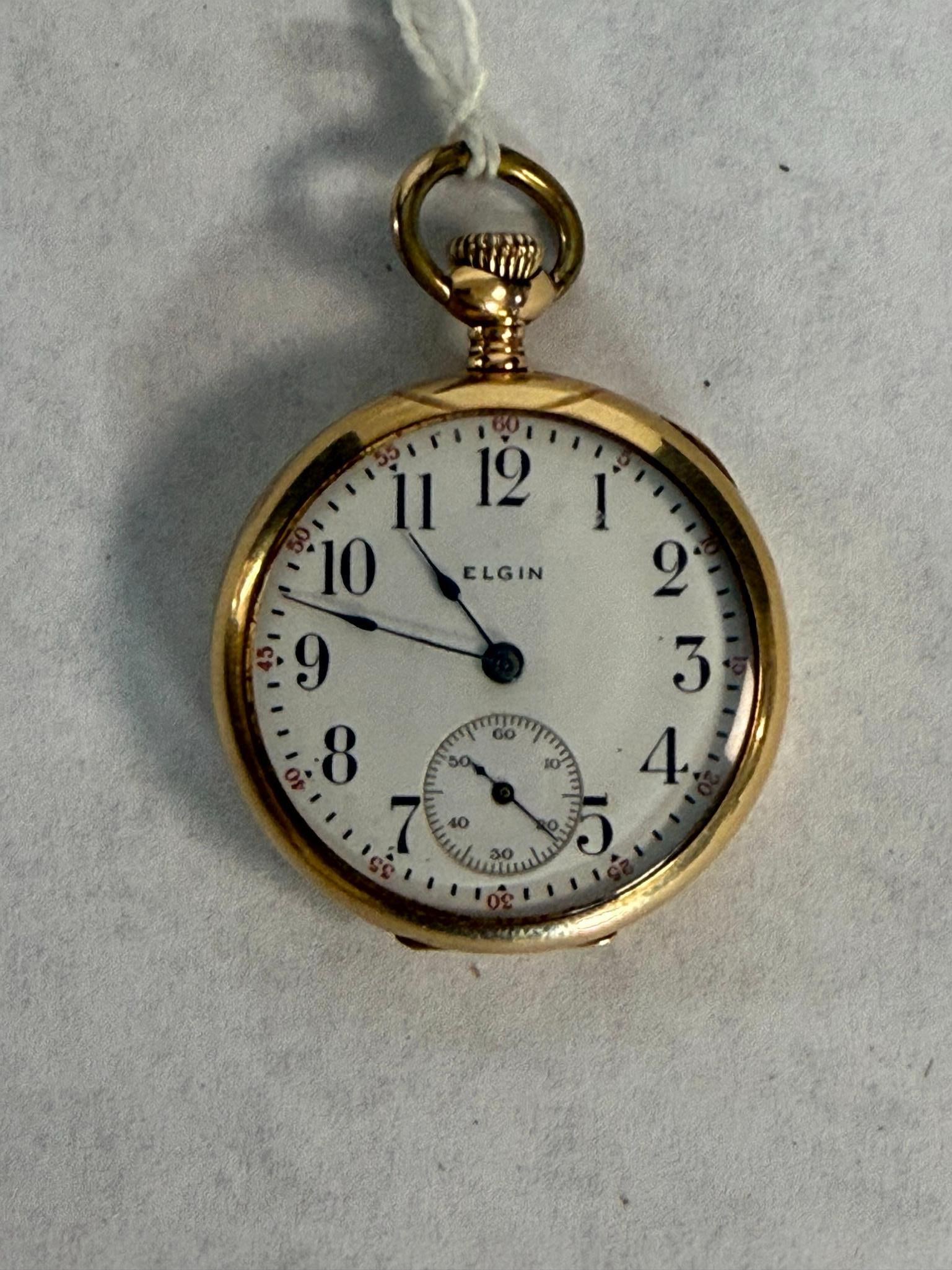 Elgin 14K Gold Open Face Pocket Watch: An Elgin National Watch Co. A sunken sub-seconds dial is positioned at the 6 o'clock mark. The manual-wind movement is constructed with a nickel finish and decorative damaskeening, signed Elgin U.S.A.