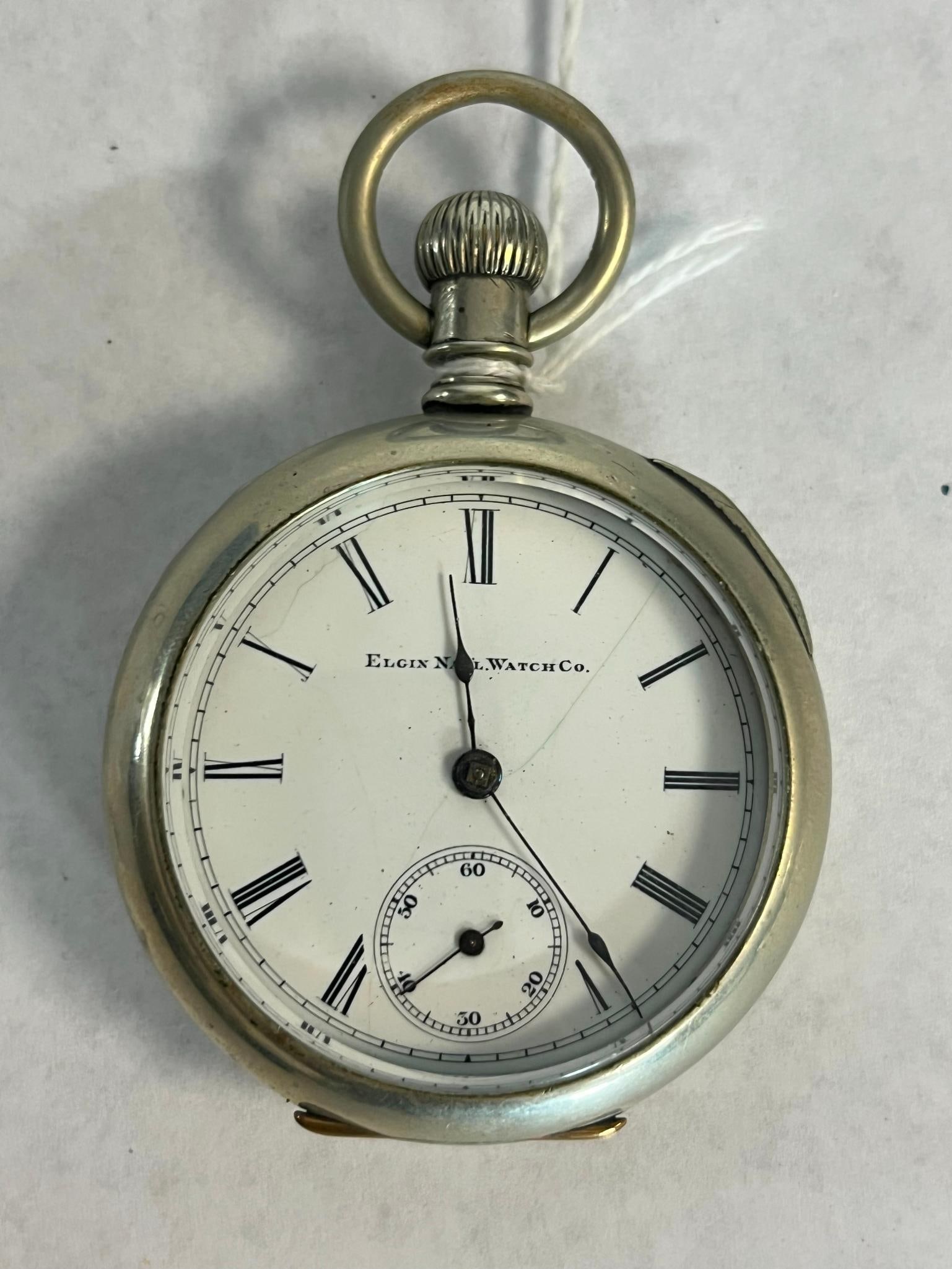 Elgin Silveroid Key Wind Pocket Watch: This is an antique open-face pocket watch manufactured by the Elgin National Watch Company, dated to approximately 1888. A black printed mark on the dial reads ELGIN NATL WATCH Co. The mechanical