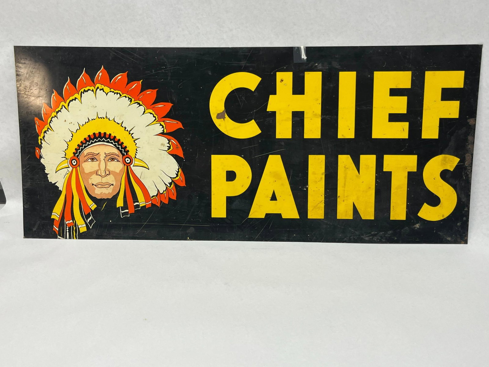 Chief Paints Metal Sign w/ Imprint: This is a rectangular advertising sign for Chief Paints, executed in painted metal. No manufacturer marks or date stamps are present. Dimensions: 28 in. L x 12 in. H.