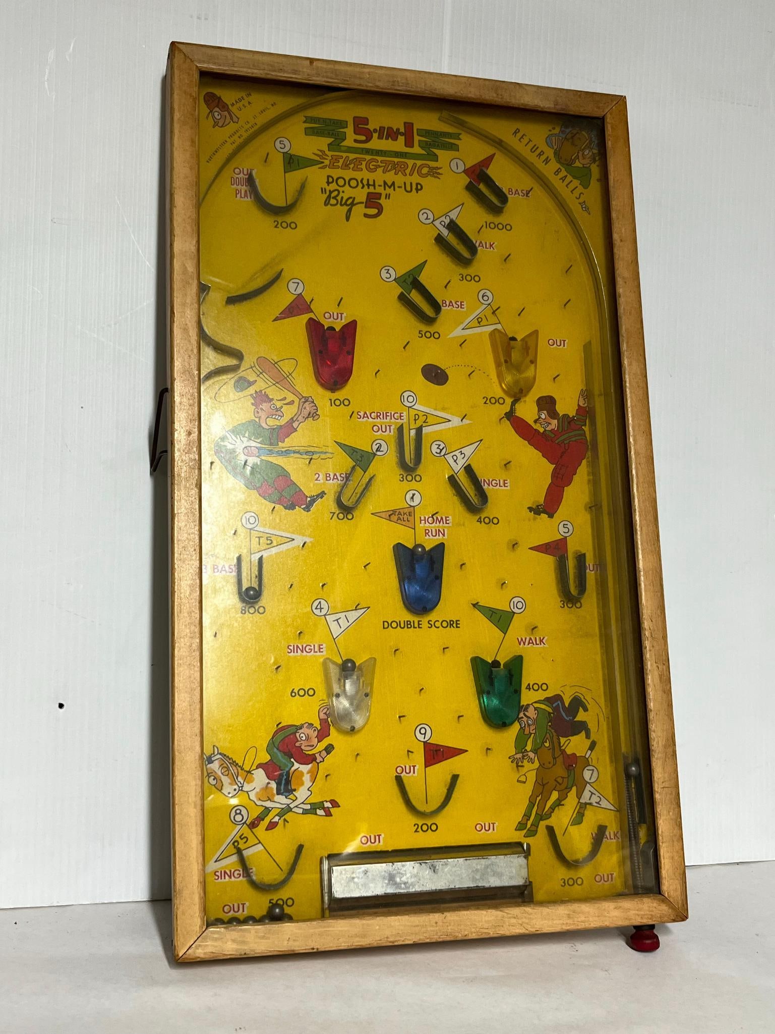 Northwestern 5-In-1 Poosh-M-Up Pinball: This Northwestern Products Co. The unit features a stained wood frame and a glass cover over a paper-on-board lithograph playfield. A printed mark on the top left of the playfield reads MADE IN