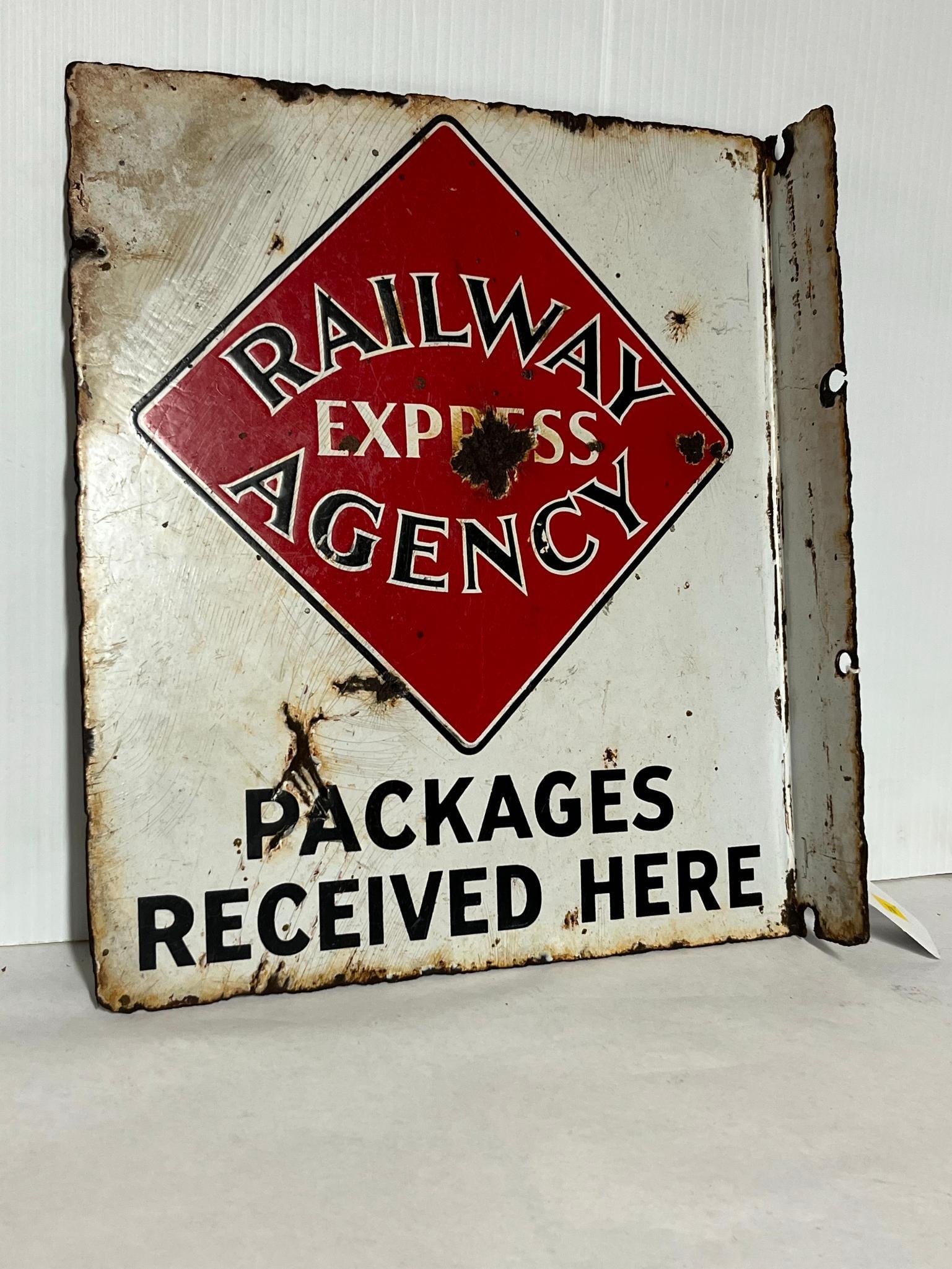 Railway Express Agency Porc. Flange: A American double-sided flange sign for the Railway Express Agency. This heavy-gauge metal sign features a porcelain enamel finish. The design consists of a white field with a central red diamond