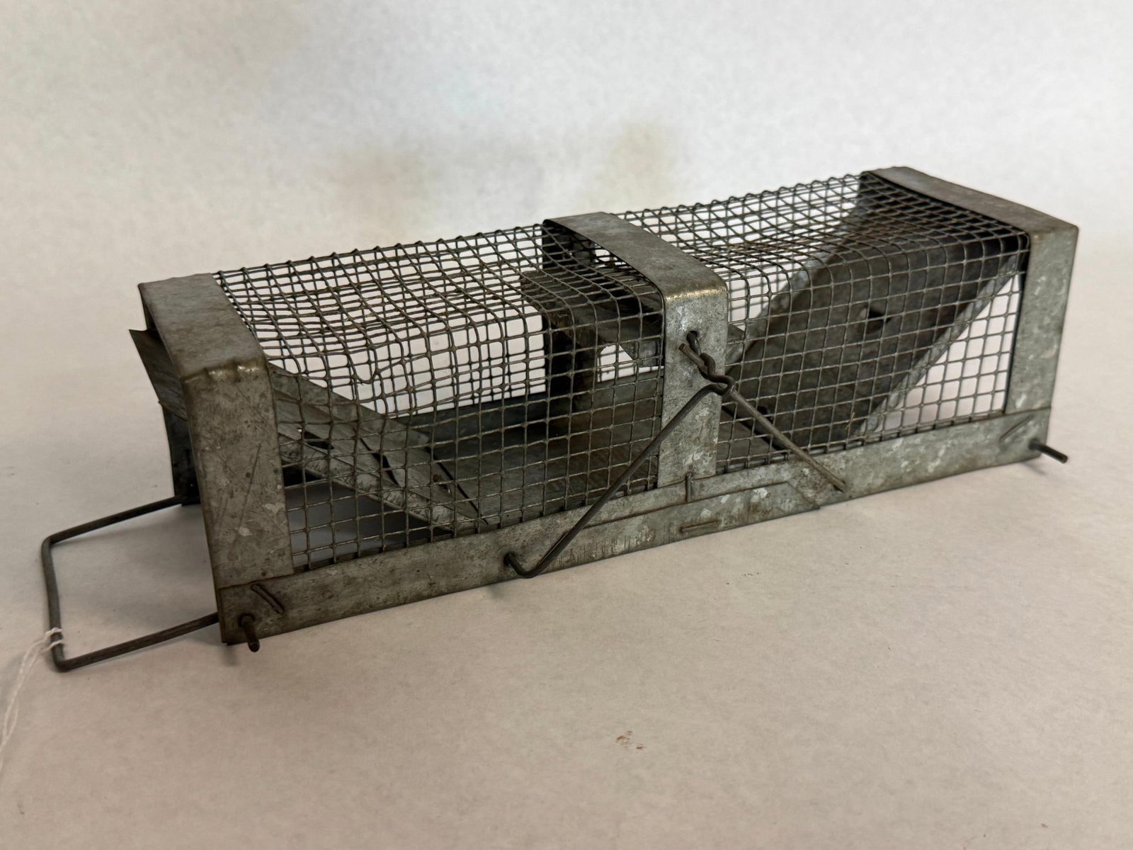 Havahart 2-Door Galv. Steel Cage Trap: A mid-20th-century galvanized steel live animal cage trap. The rectangular cage is constructed of wire mesh supported by a sheet metal frame. The top sheet metal panel features an embossed maker mark
