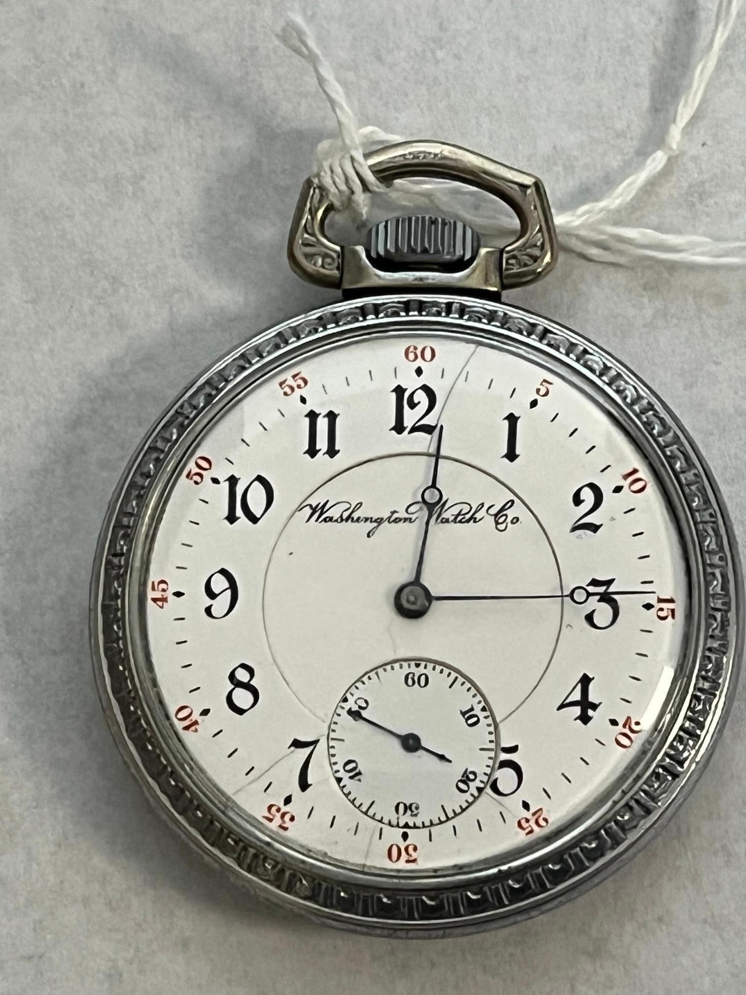 Washington Co. Army & Navy Pocket Watch: This open-face pocket watch was manufactured by the Washington Watch Company, a brand produced by the Illinois Watch Company. The white porcelain enamel dial features black Arabic numerals for the