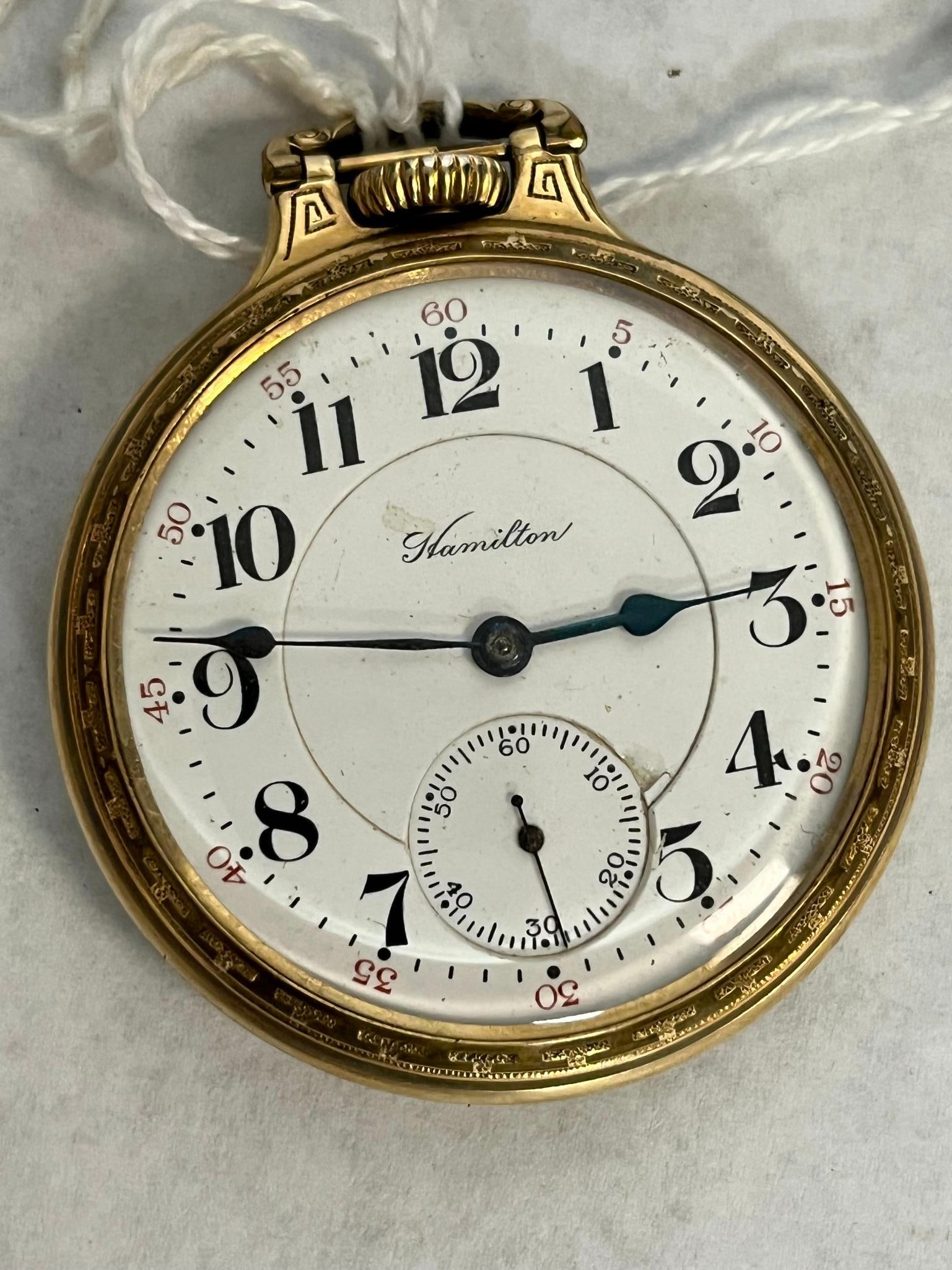 Hamilton 992 21 Jewel Pocket Watch: This open-face pocket watch features a railroad grade 992 manual wind movement manufactured by the Hamilton Watch Company in Lancaster, Pennsylvania. The white porcelain enamel dial is signed with