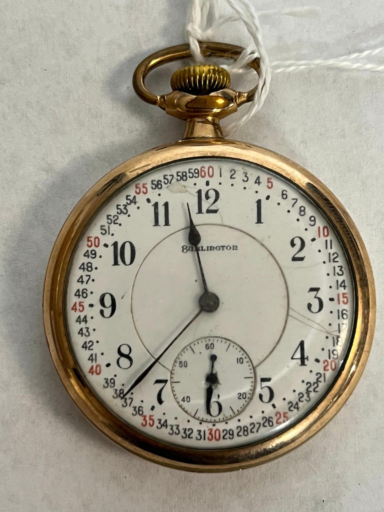 Burlington Co. 21-Jewel Pocket Watch: A Burlington Watch Co. The white enamel marginal minute dial is printed with black Arabic numerals for hours and every minute, with every fifth minute marked in red. The interior of the yellow