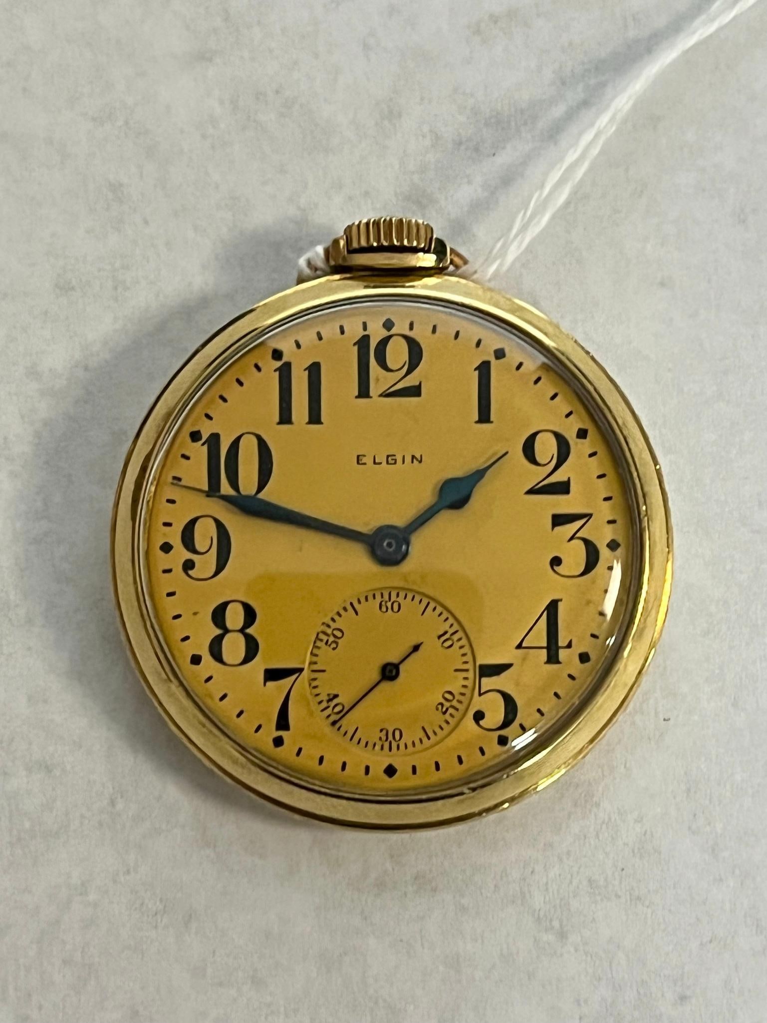Elgin 10K Open-Face Pocket Watch c.1937: An American-made open-face pocket watch featuring a manual wind mechanical movement with 15 jewels. The hands are blued steel in spade and whip styles. The movement is engraved with the text ELGIN