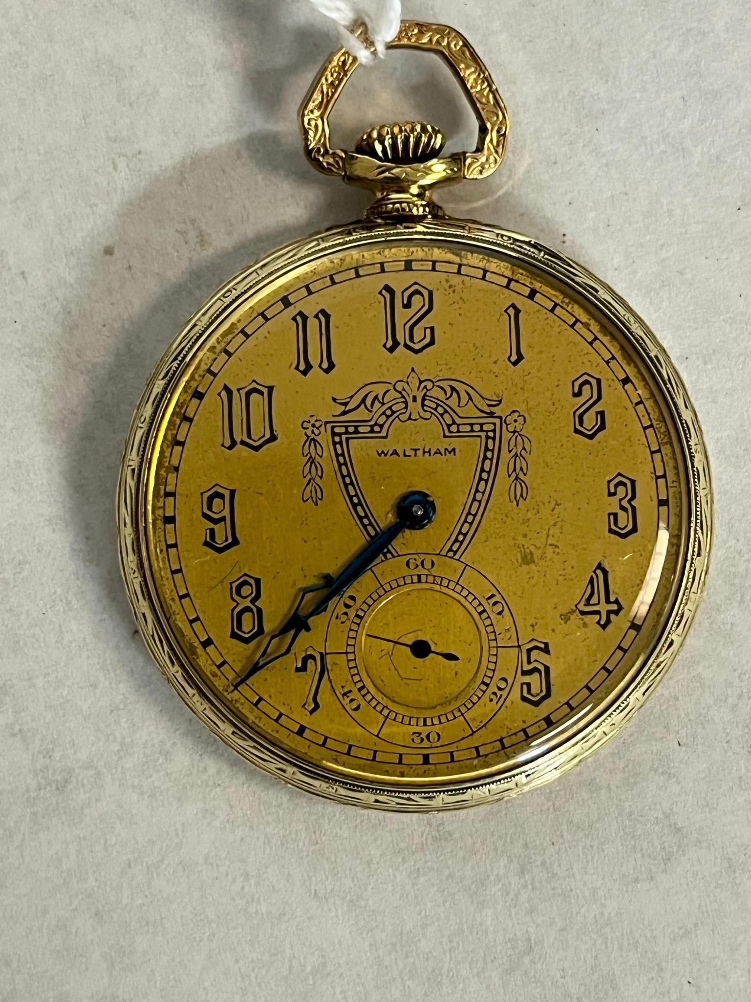 Waltham 14K Gold Filled Pocket Watch: An American-made Waltham Colonial model pocket watch dating to approximately 1920. Black Art Deco style Arabic numerals mark the hours, enclosed by a railroad minute track. The regulator is marked