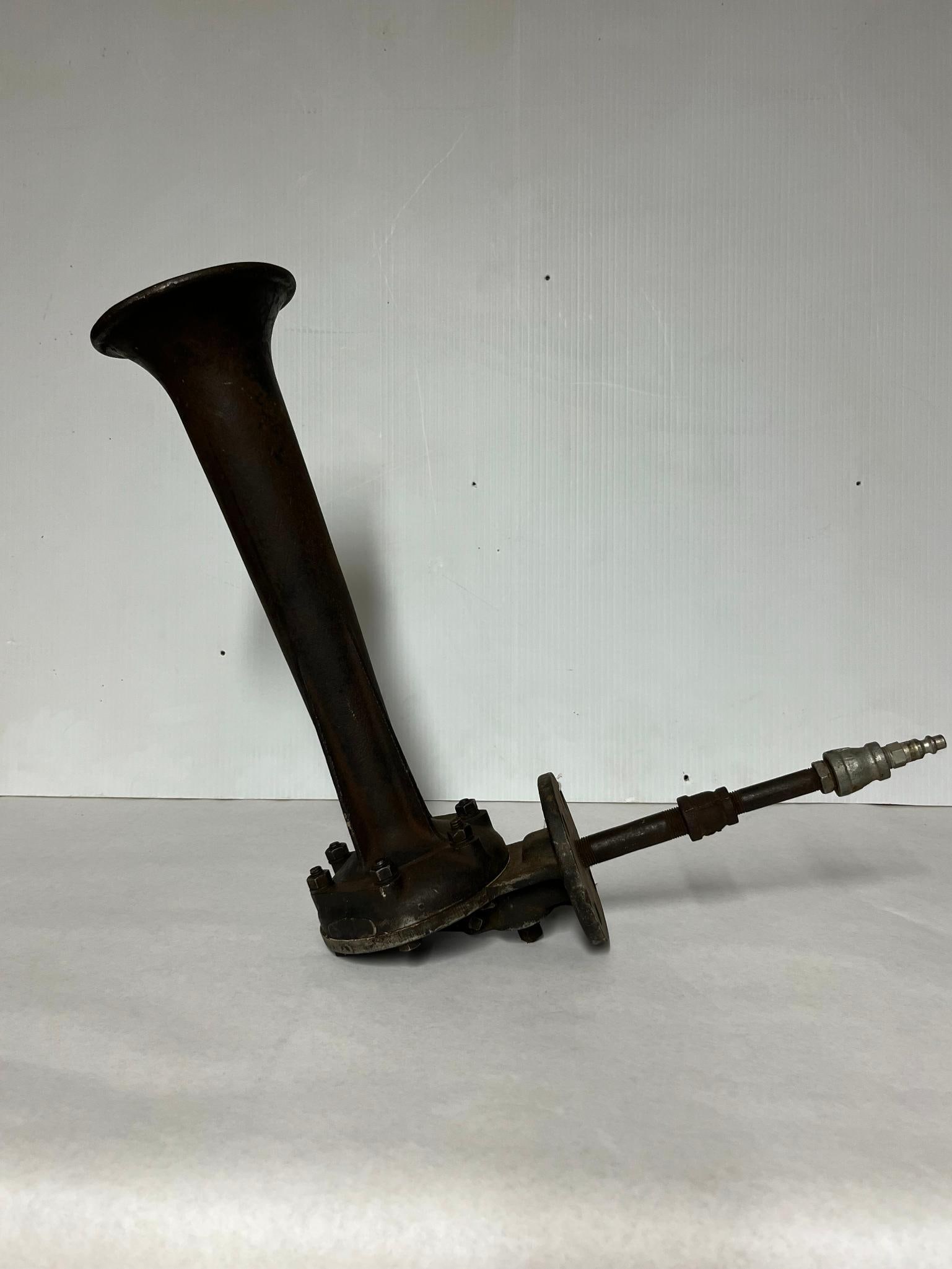 Cast Iron Industrial Air Horn w/ Flange: A single-chime air horn constructed from heavy cast iron. The exterior of the horn bell is impressed with a mark consisting of two V-shapes forming a stylized letter W inside a diamond-shaped border,