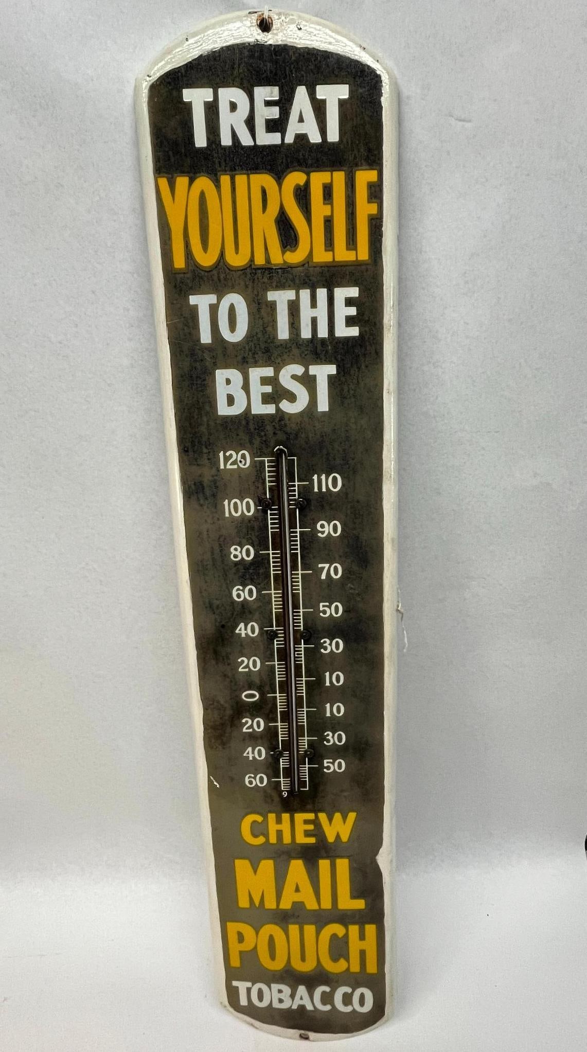 Mail Pouch Tobacco Thermometer Sign: A vertical advertising thermometer sign for Mail Pouch Tobacco, constructed from painted sheet metal. The lower section reads CHEW MAIL POUCH TOBACCO in yellow and white. The thermometer glass tube