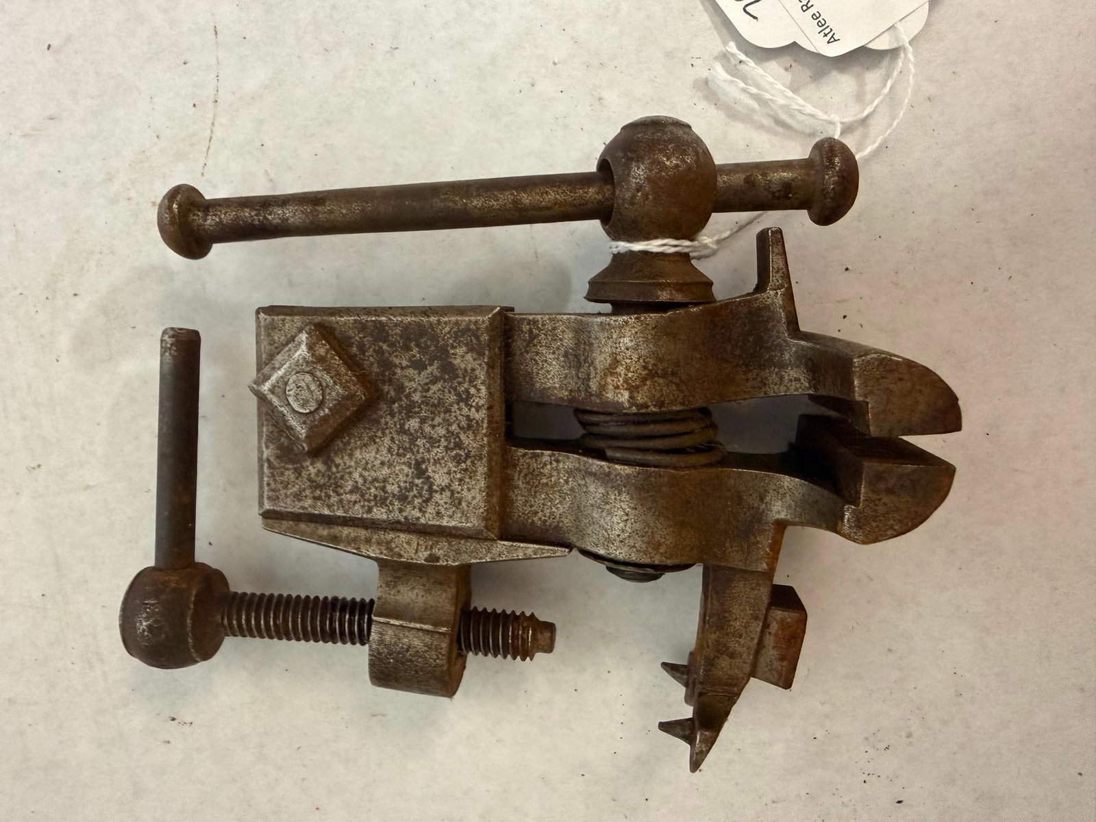 Antique Iron Bench Vise w/ Table Clamp: This is a miniature combination bench vise and mounting clamp constructed from iron or steel. No manufacturer names, stamps, or patent dates are discernible on the metal surfaces of the tool.