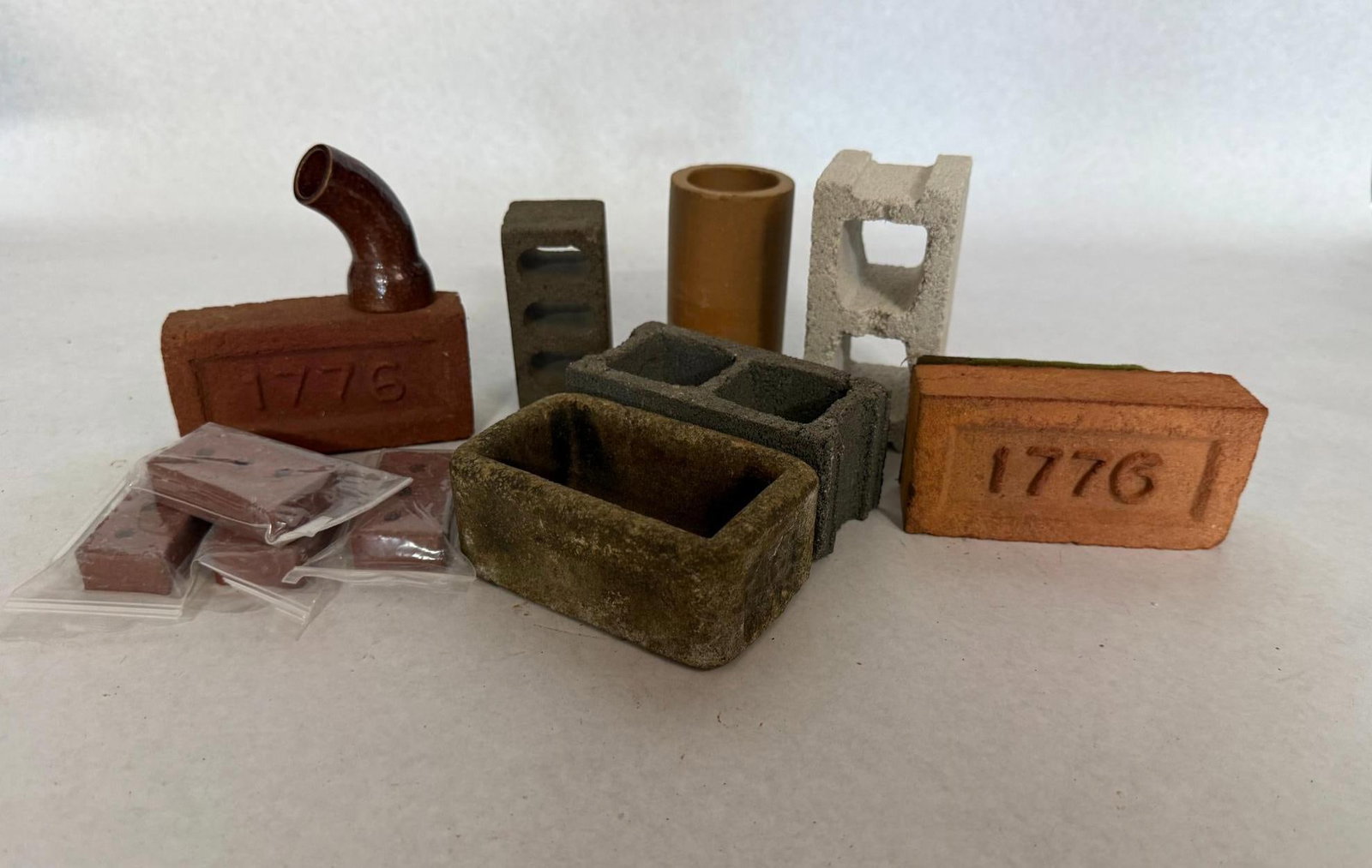 Miniature Building & Architectural Set: This collection features a variety of miniature architectural building supplies crafted from materials such as terracotta, clay, ceramic, and cast stone or concrete. The collection further contains a