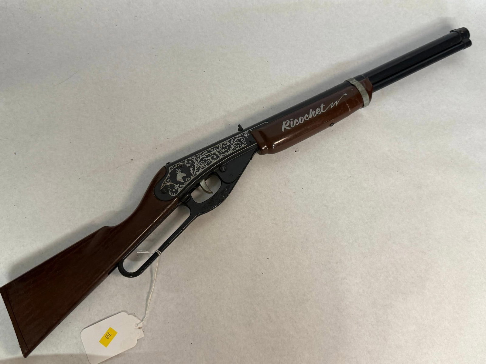 Daisy Model 660 Ricochet Toy Rifle: A lever-action toy sound rifle manufactured by the Daisy Manufacturing Co. The toy is constructed with a black painted metal barrel and receiver, paired with a dark brown plastic stock and foregrip