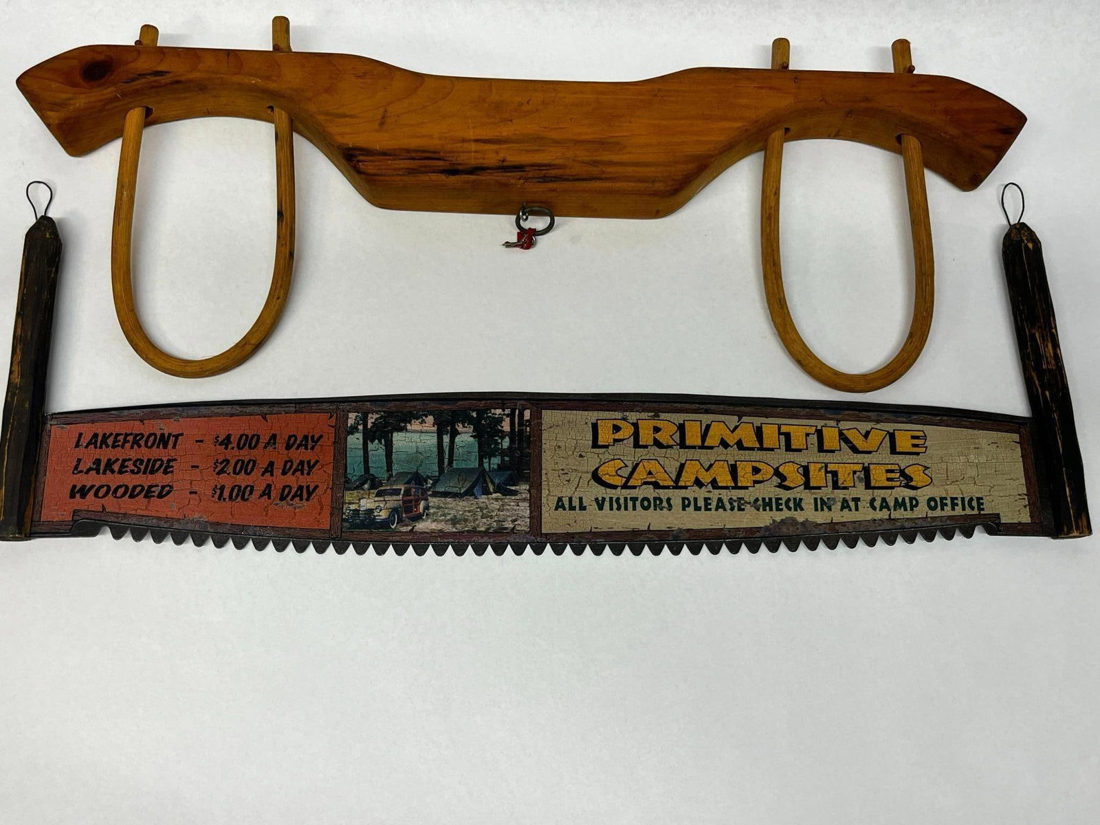 A Pair of Rustic Decorative Items Comprising a Painted Two-Man Crosscut Saw and a Wooden Ox Yoke (1 of 5)